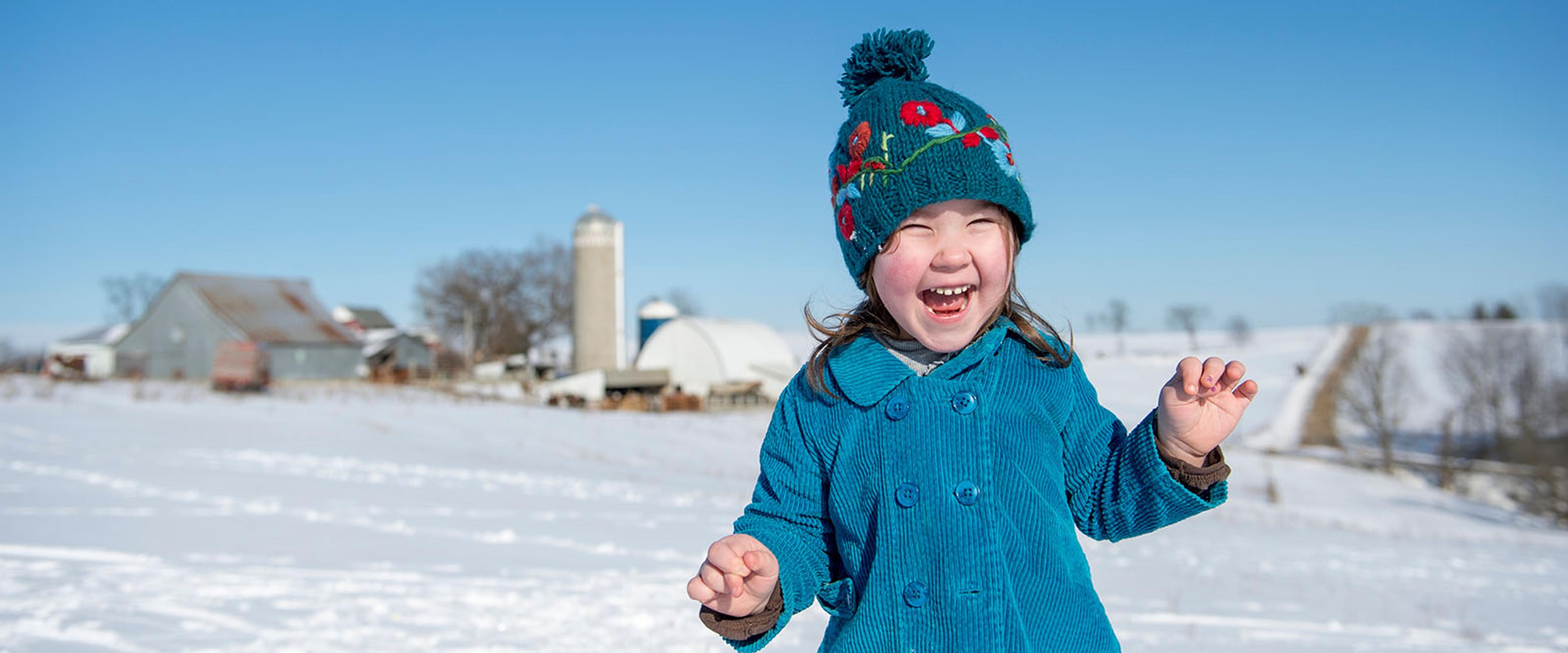 Little girl on farm laughing