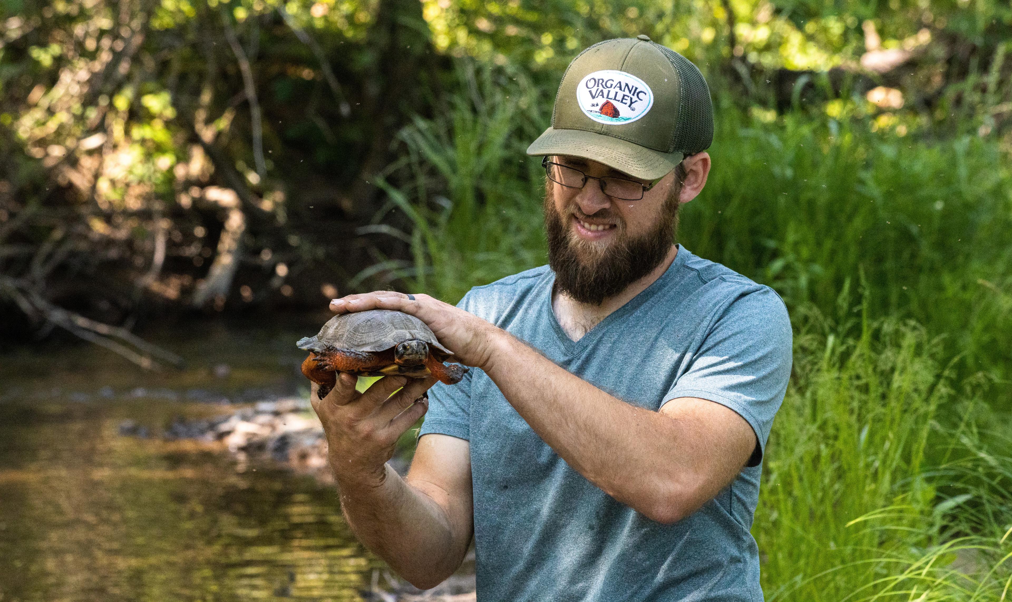 Andrew Ranck holds a turtle on his organic farm in Pennsylvania.