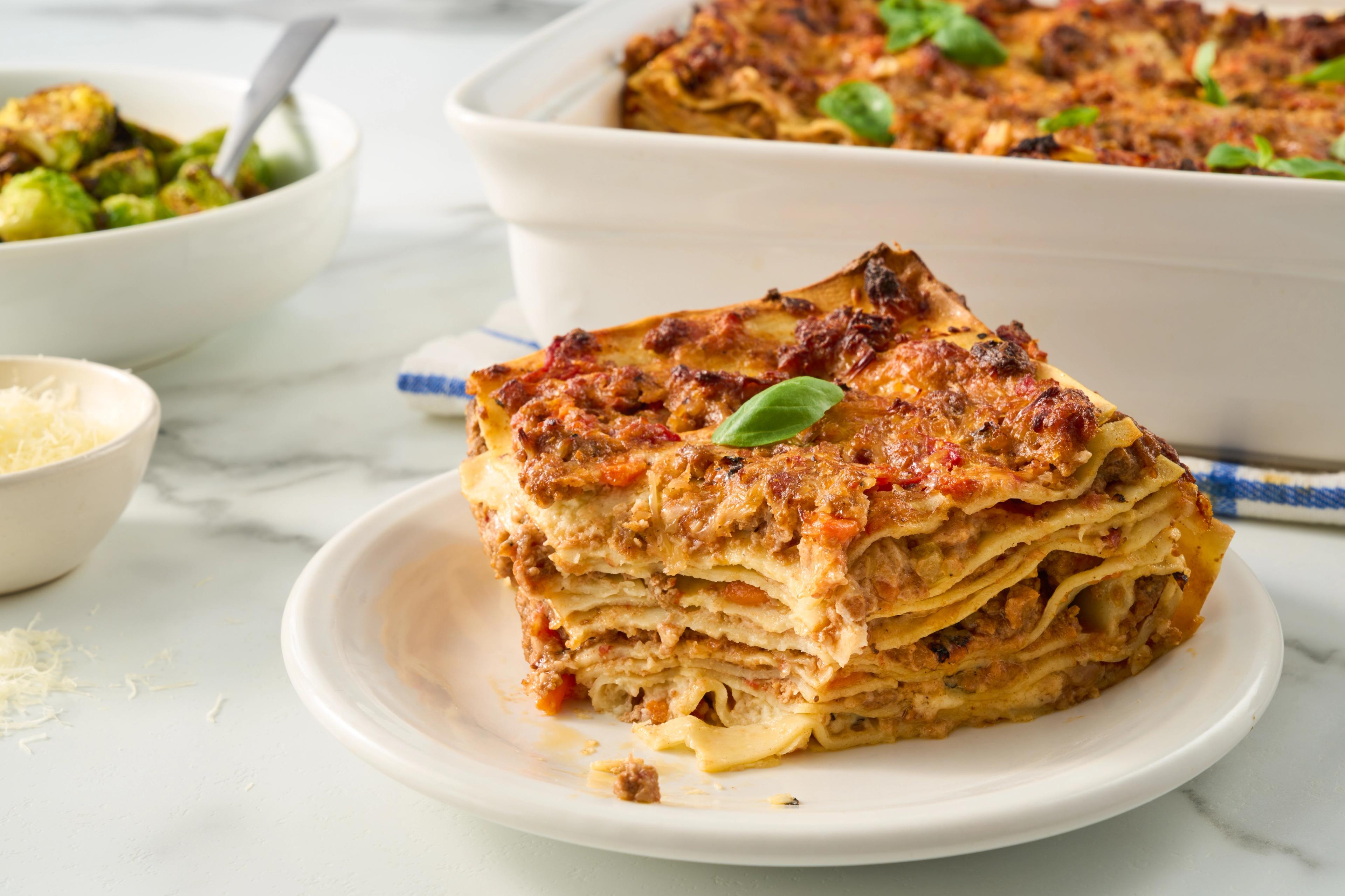 A slice of lasagna on a plate.