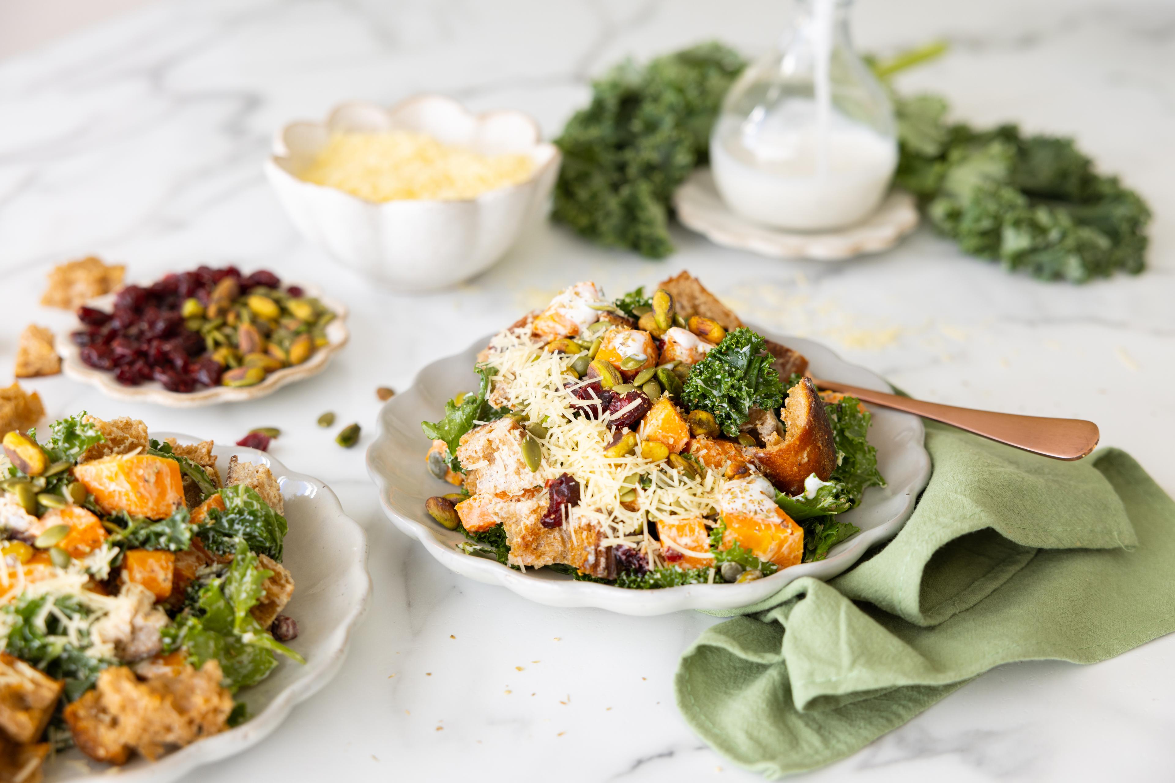 Plates of Squash Panzanella Salad on a table with a napkin.