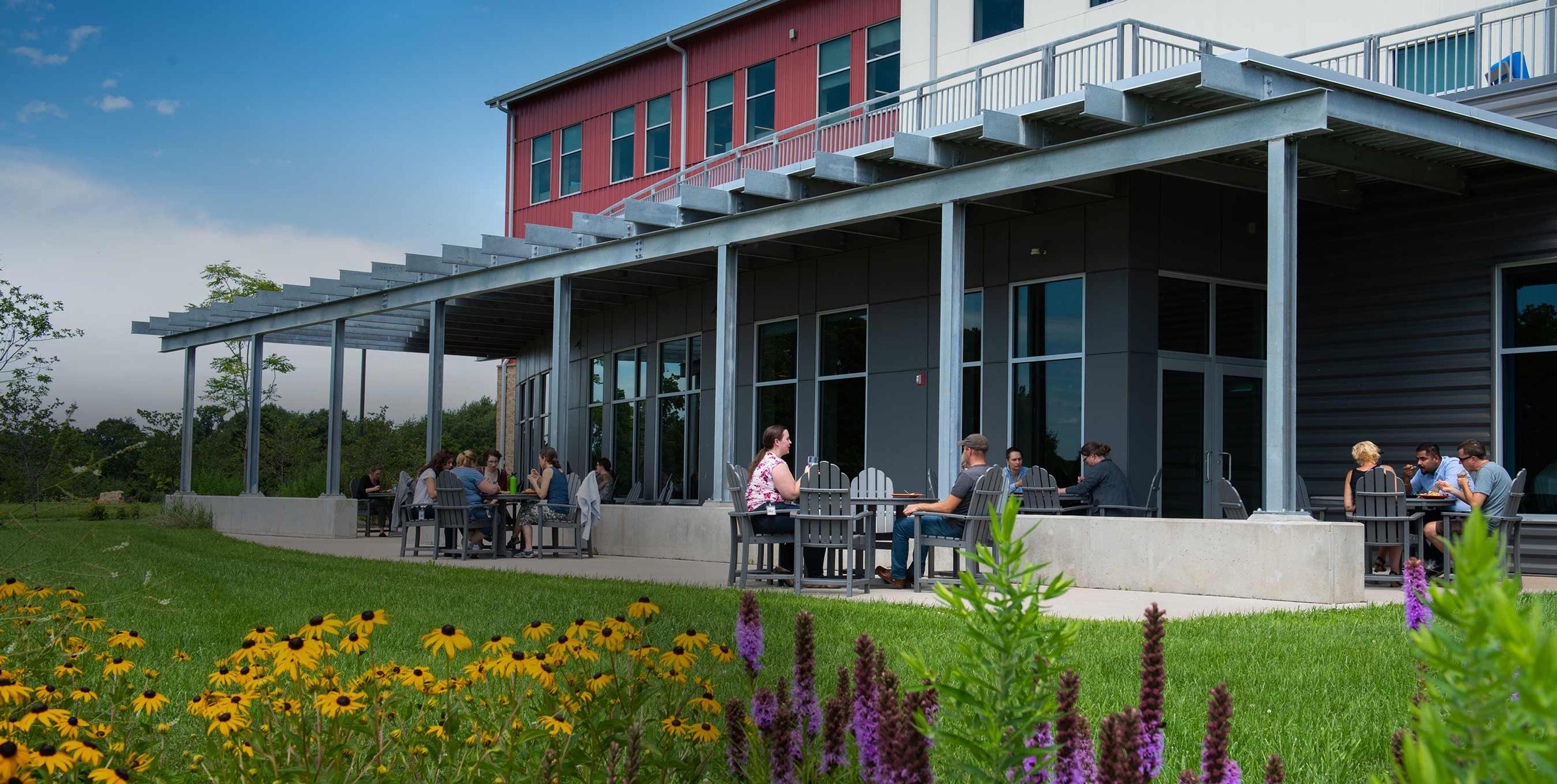 People who work at Organic Valley sitting on their outside patio for lunch.