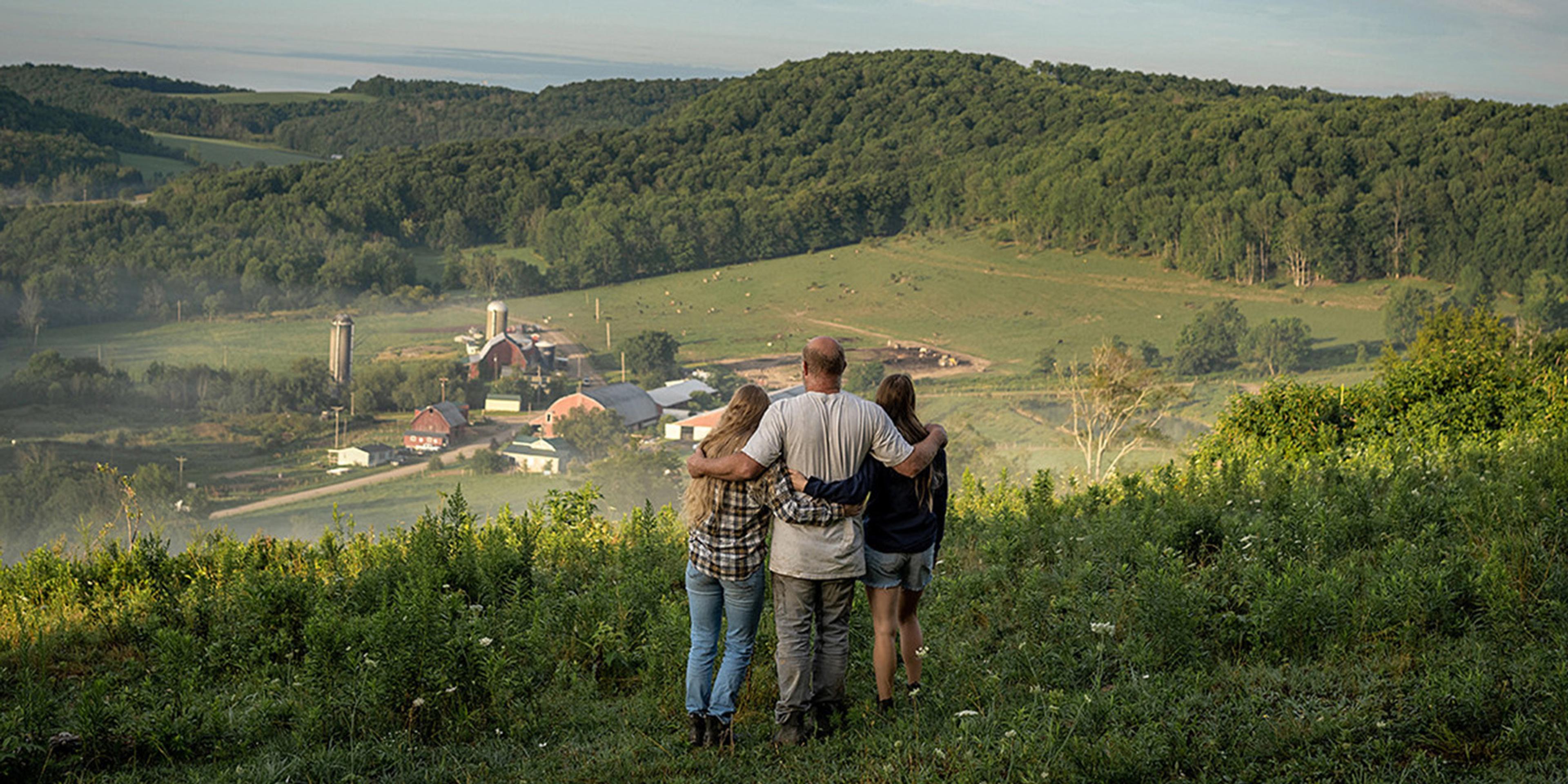 The Painters, Organic Valley farmer-members, look at their farm from a ridgetop.