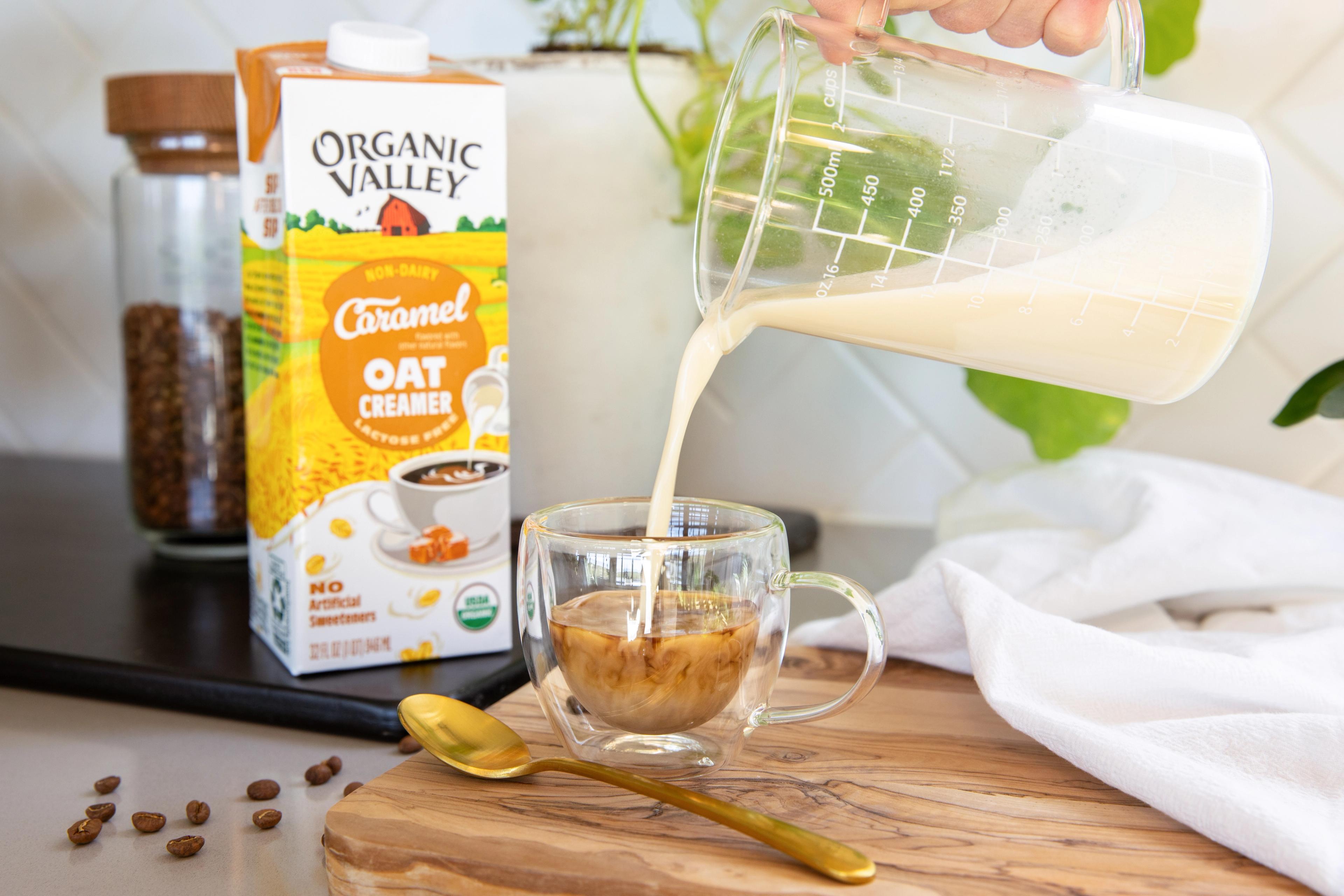 Frothed Organic Valley® Caramel Oat Creamer poured into cup of espresso. 