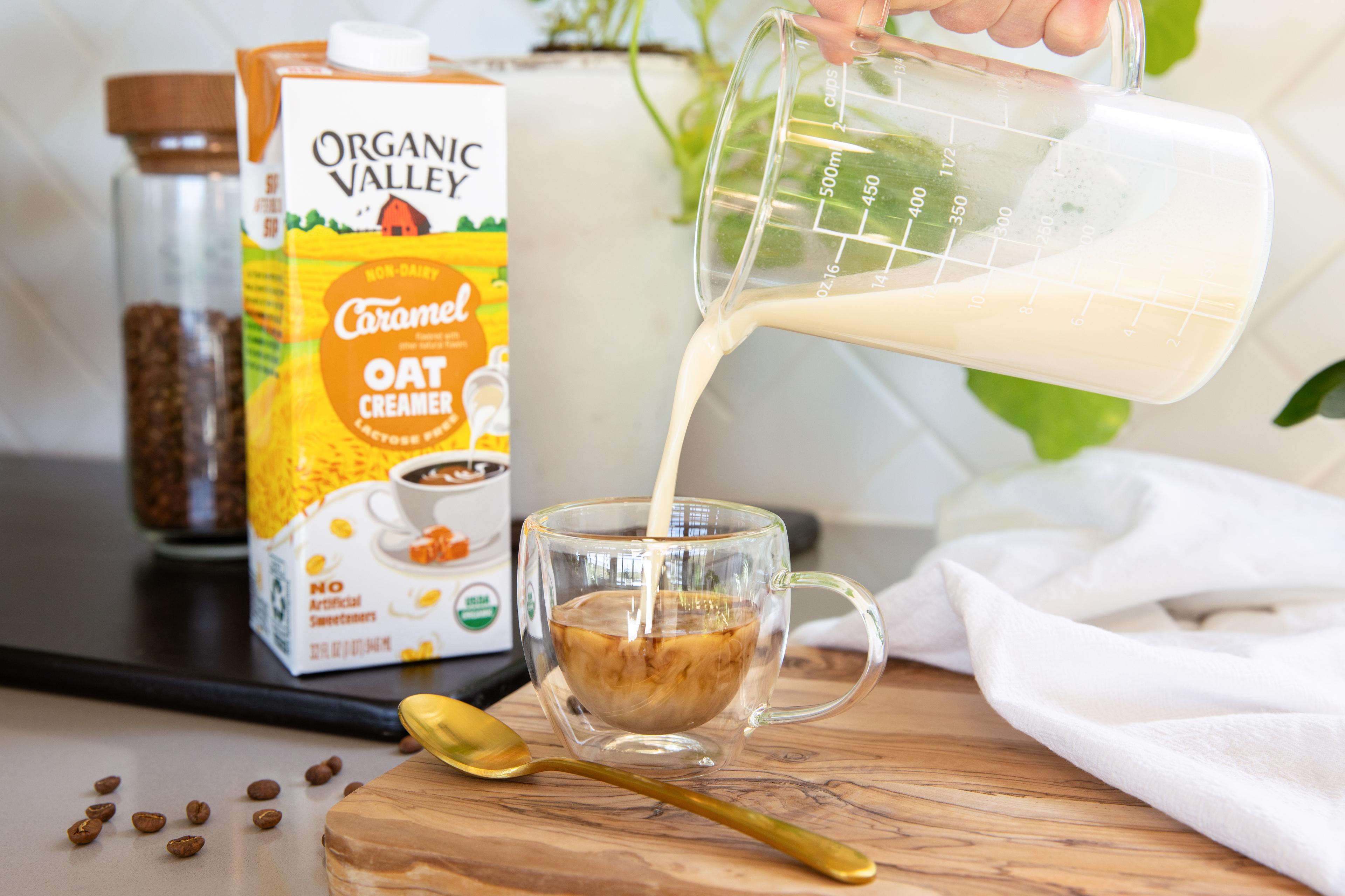 Frothed Organic Valley® Caramel Oat Creamer poured into cup of espresso.