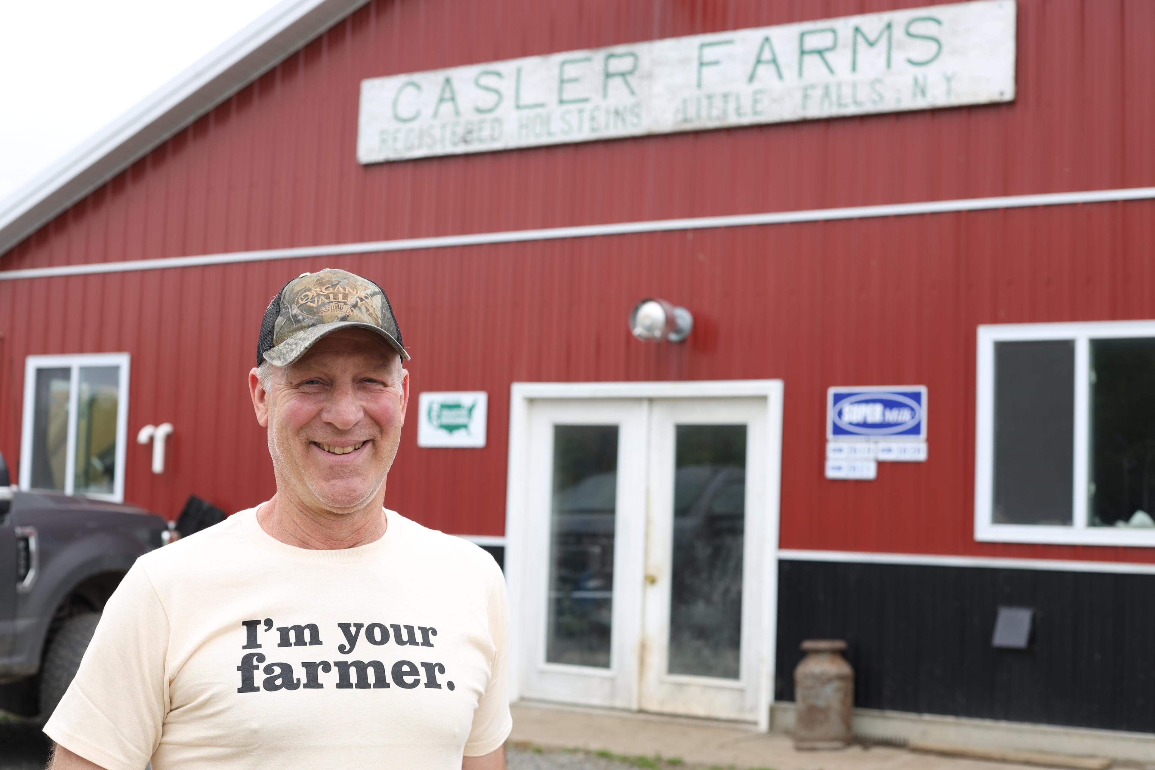 Dan Casler stands in front of a barn.
