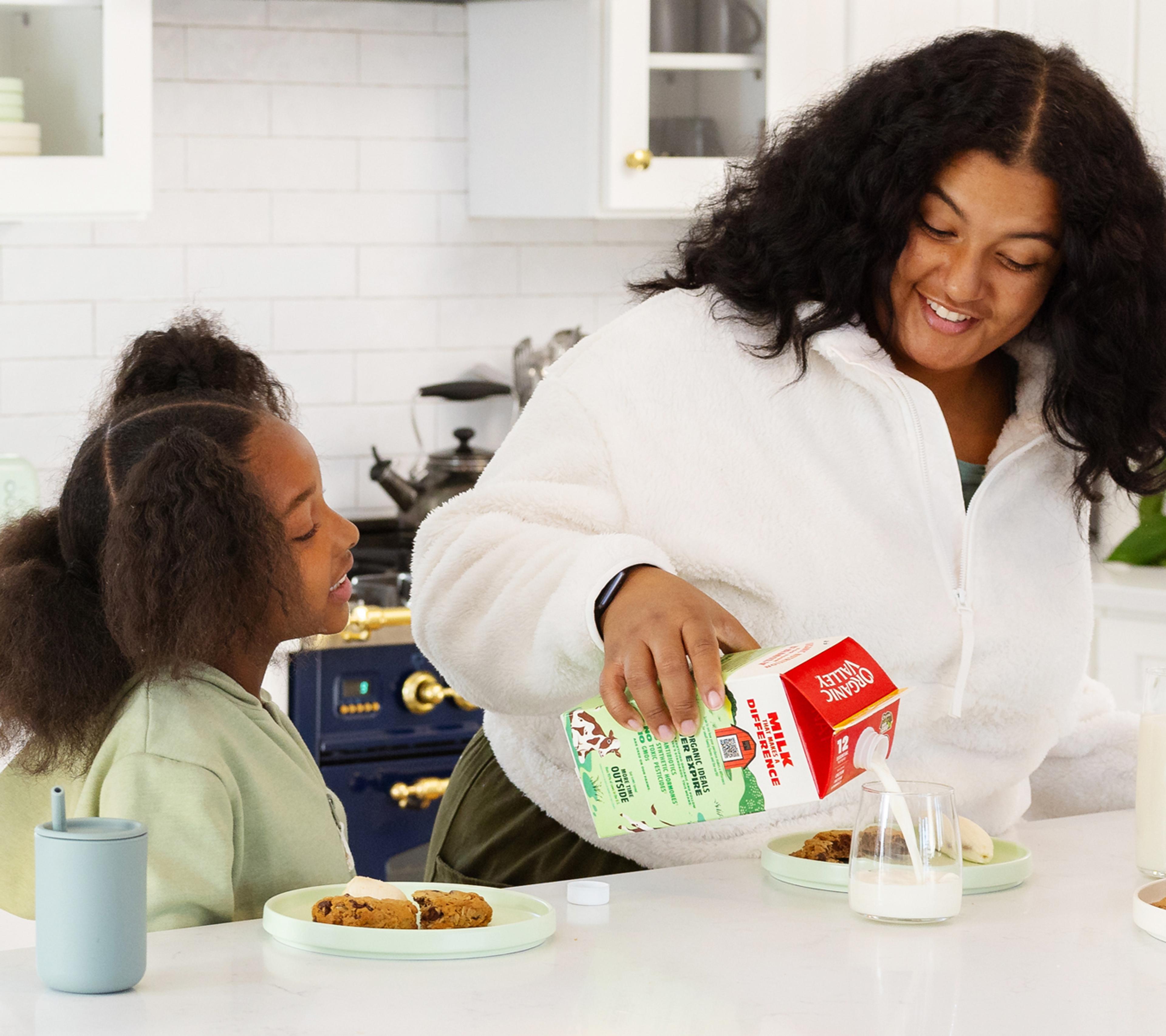 mom and daughter enjoying DHA Omega 3 milk and cookies