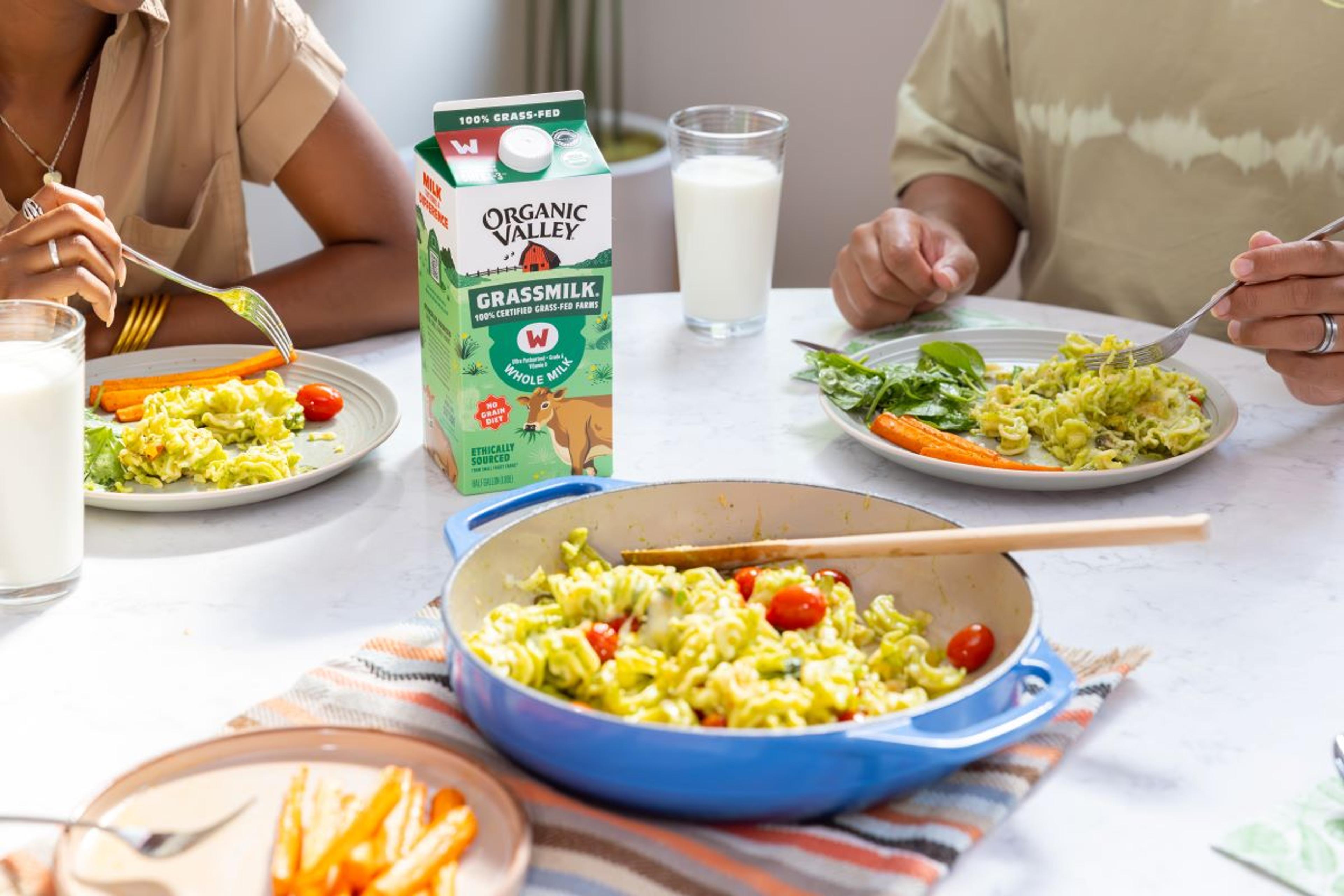 People eat eggs and drink milk at a table