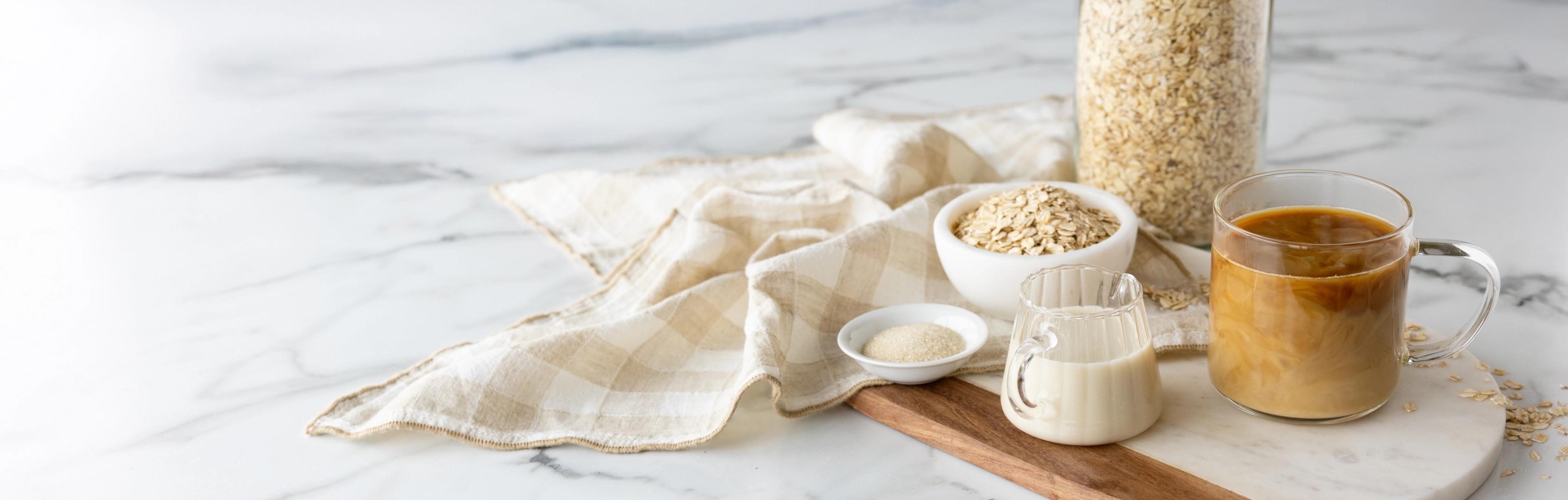 Oat and creamer on a tablecloth.