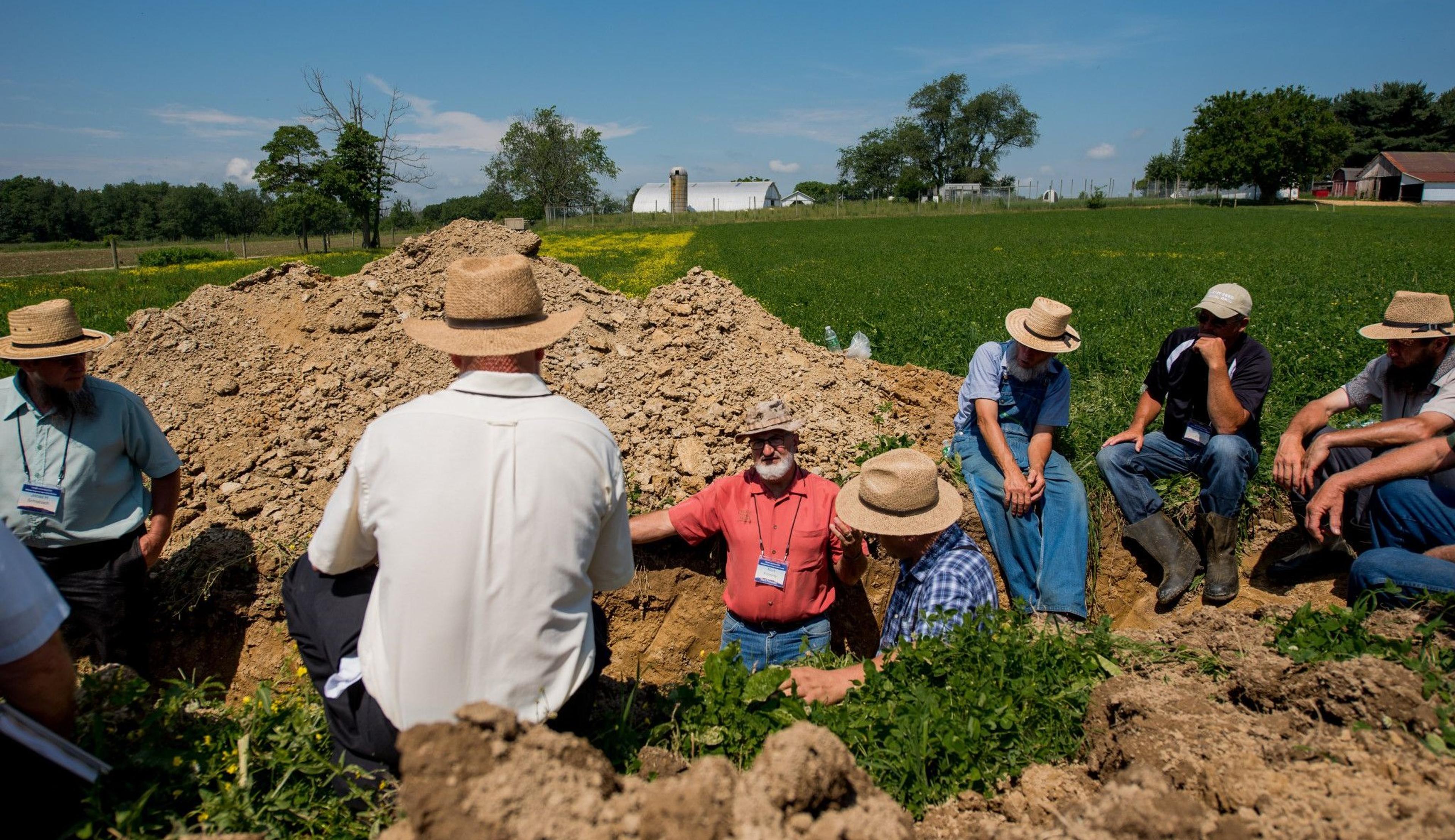 Organic Valley farmers talk about pasture management while sitting around a big pile of soil and talk soil at the Miller farm in Ohio.