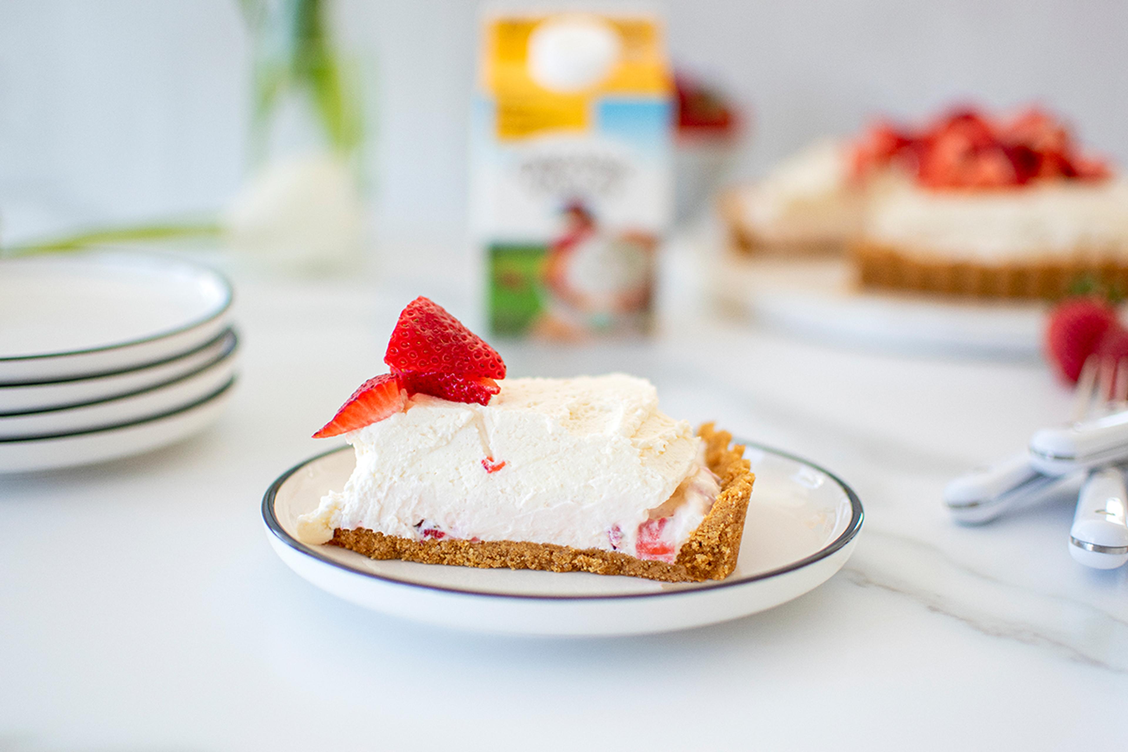 Slice of pie topped with homemade whipped cream.