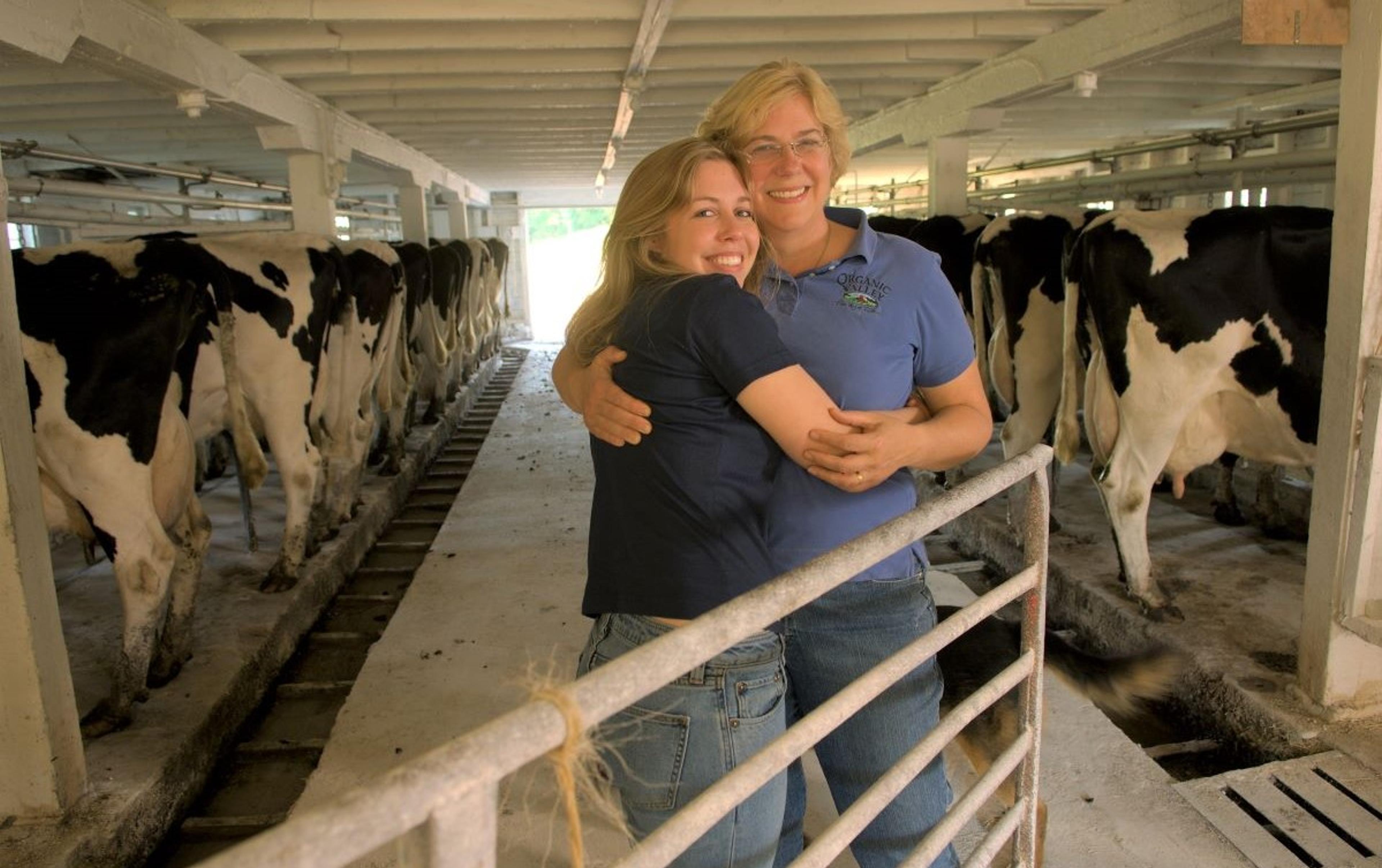 Kristina Ralph and her mother, Louise Hemstead, in the barn at their organic dairy farm.