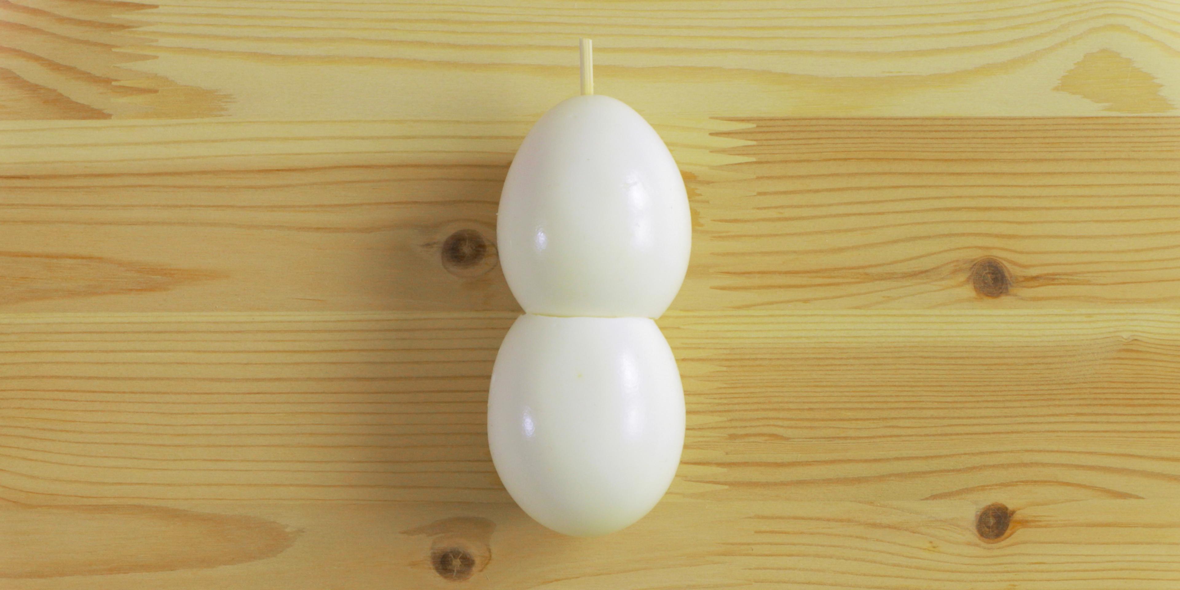 Two eggs with a skewer through them to create a snowman.