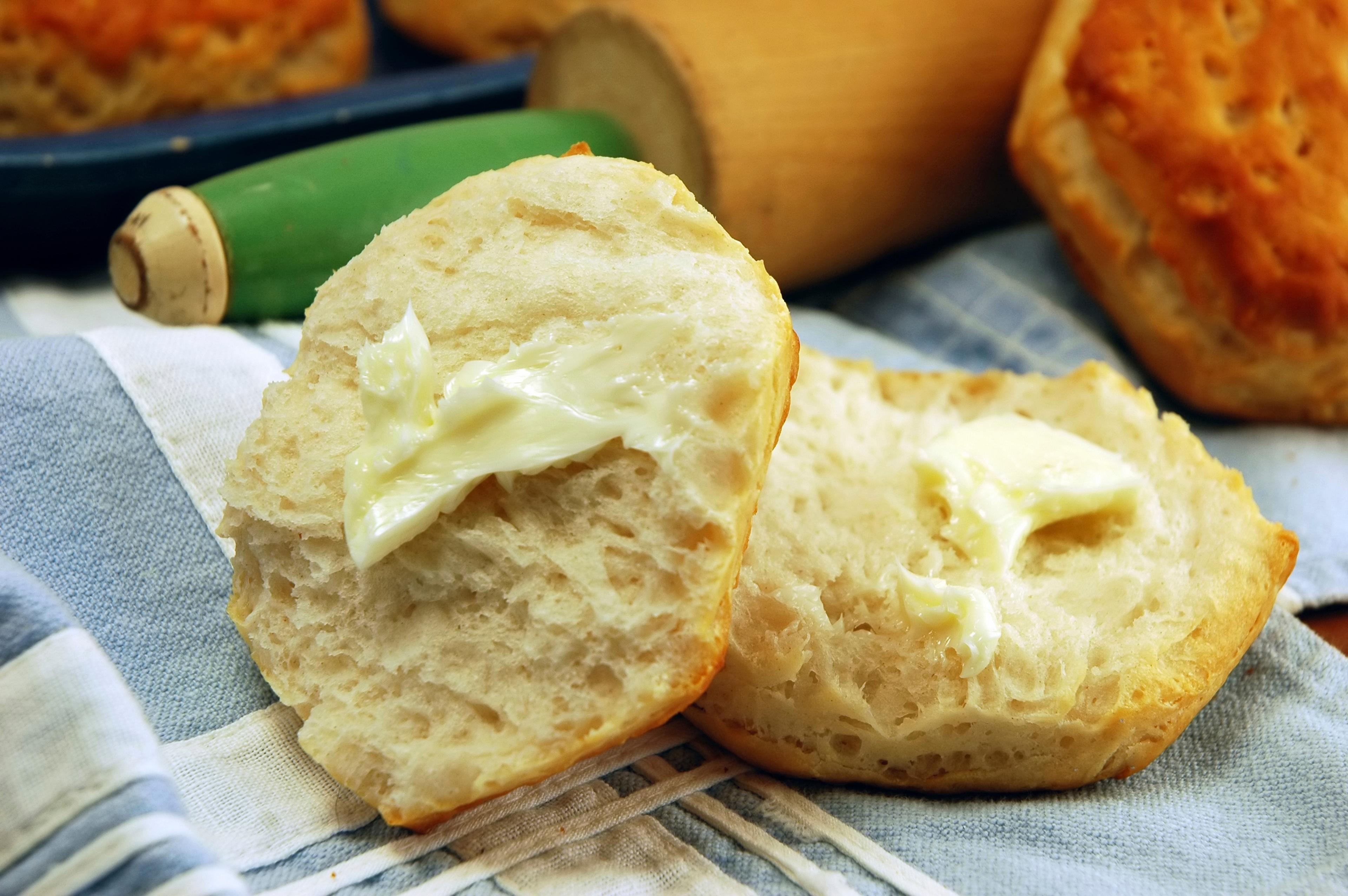 Buttermilk biscuits rest on a kitchen towel.