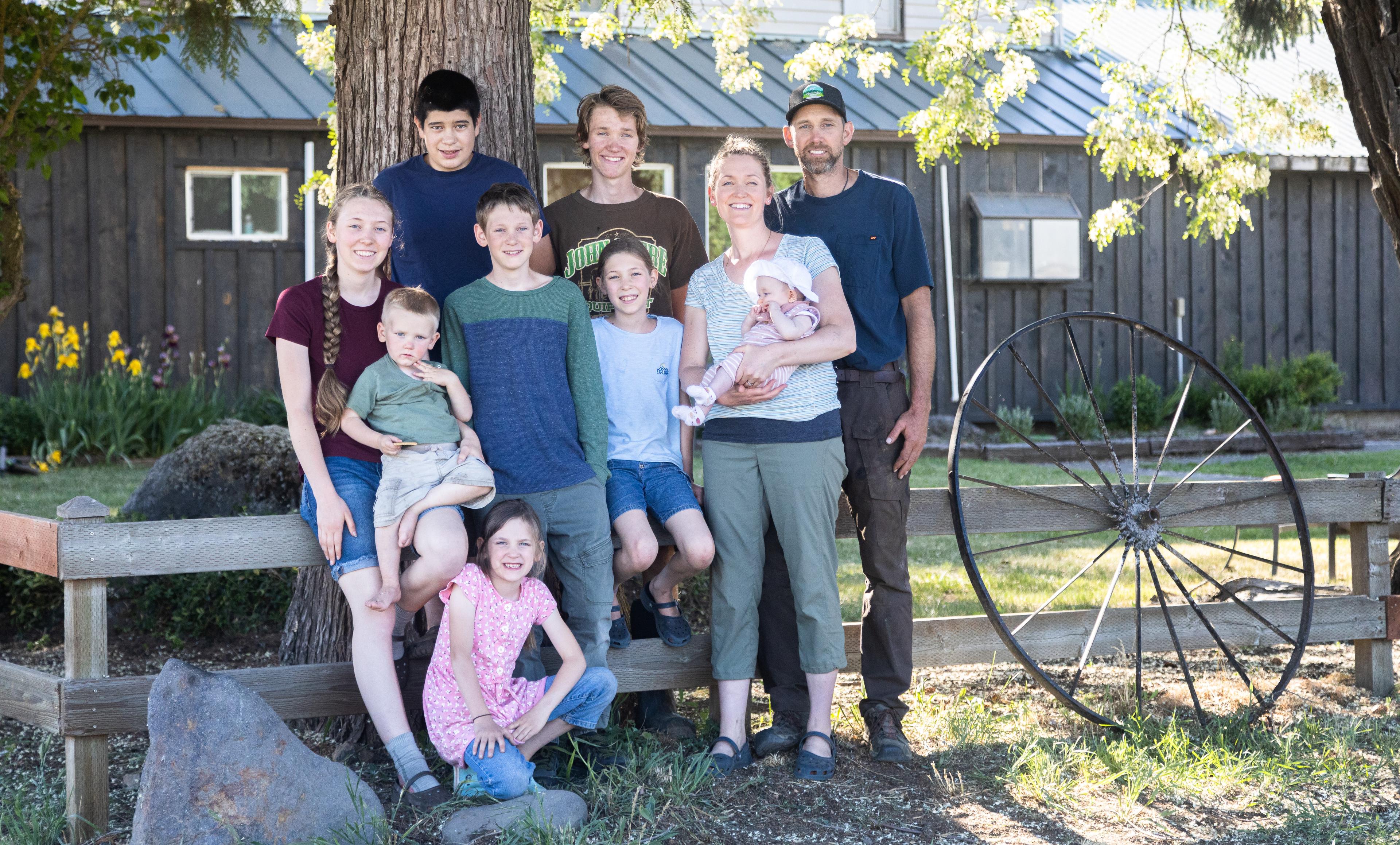 Ten members of the Pearson family pose by a fence.