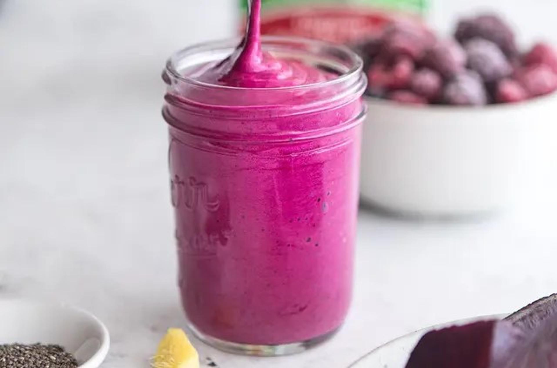 Kick-Grass Berry Beet Smoothie being poured in a jar