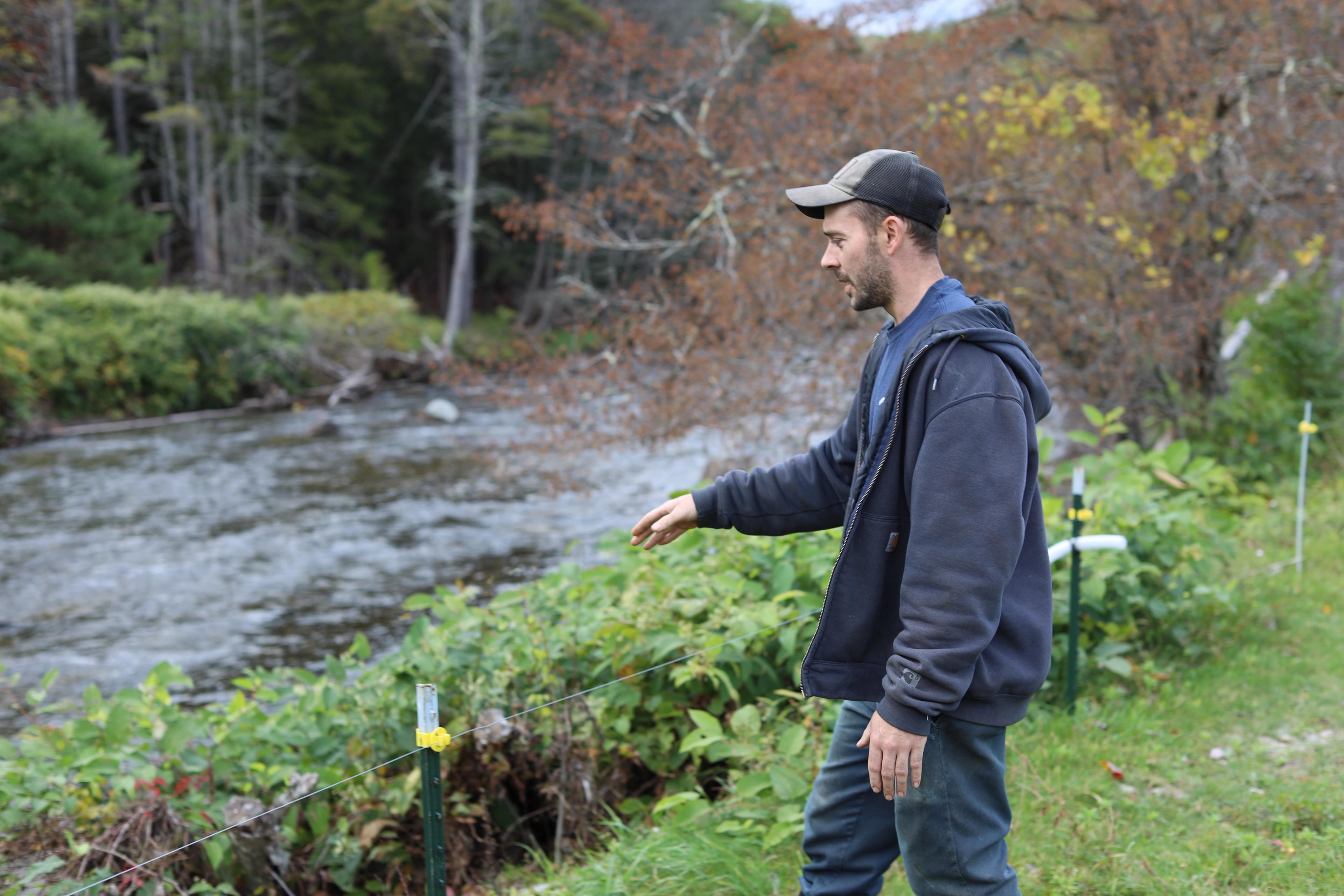 Farmer Kyle Leibold walks near a river. 