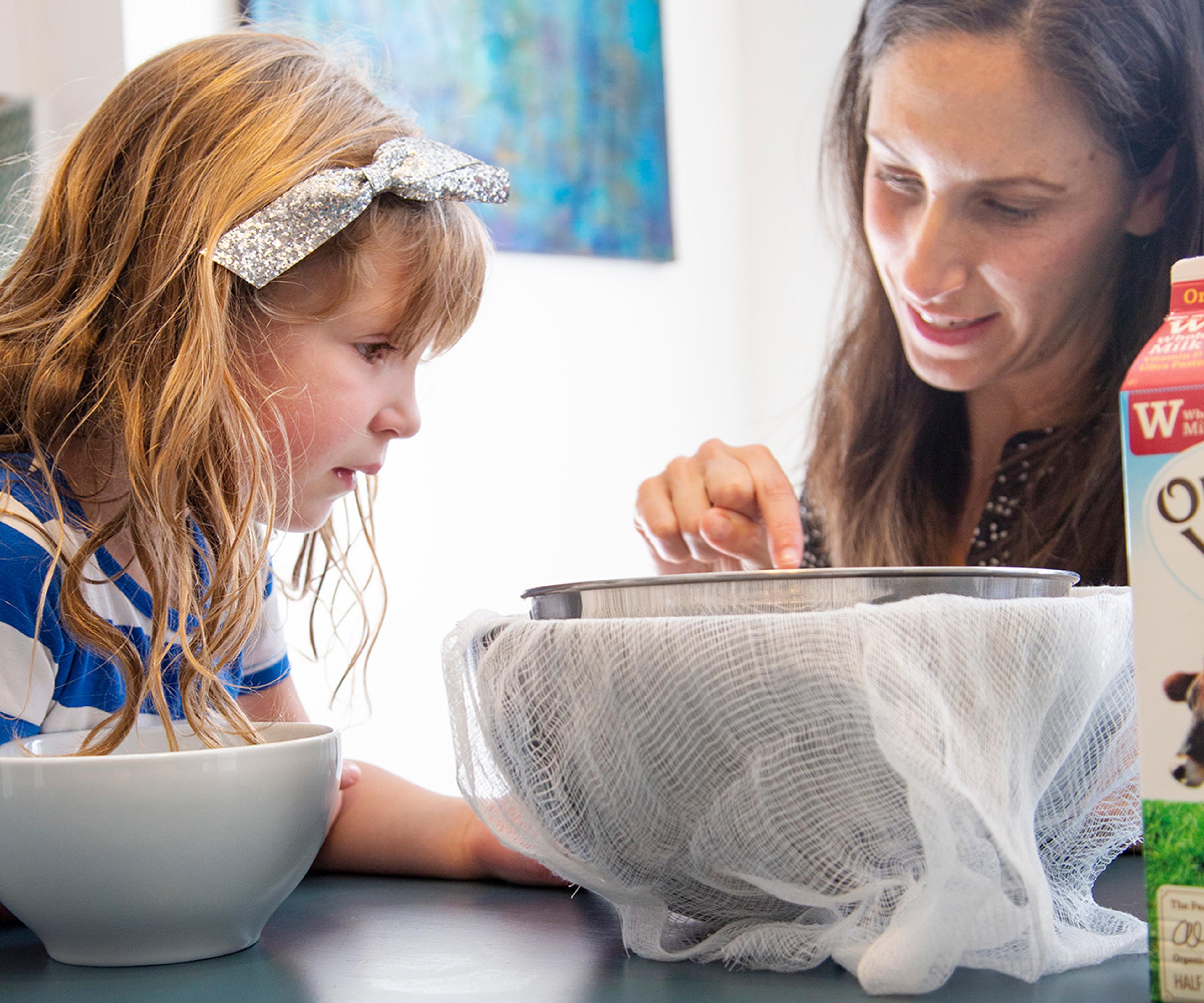 Lauren Manaker and her daughter make homemade ricotta cheese. Photo by Jackie Stofsick.