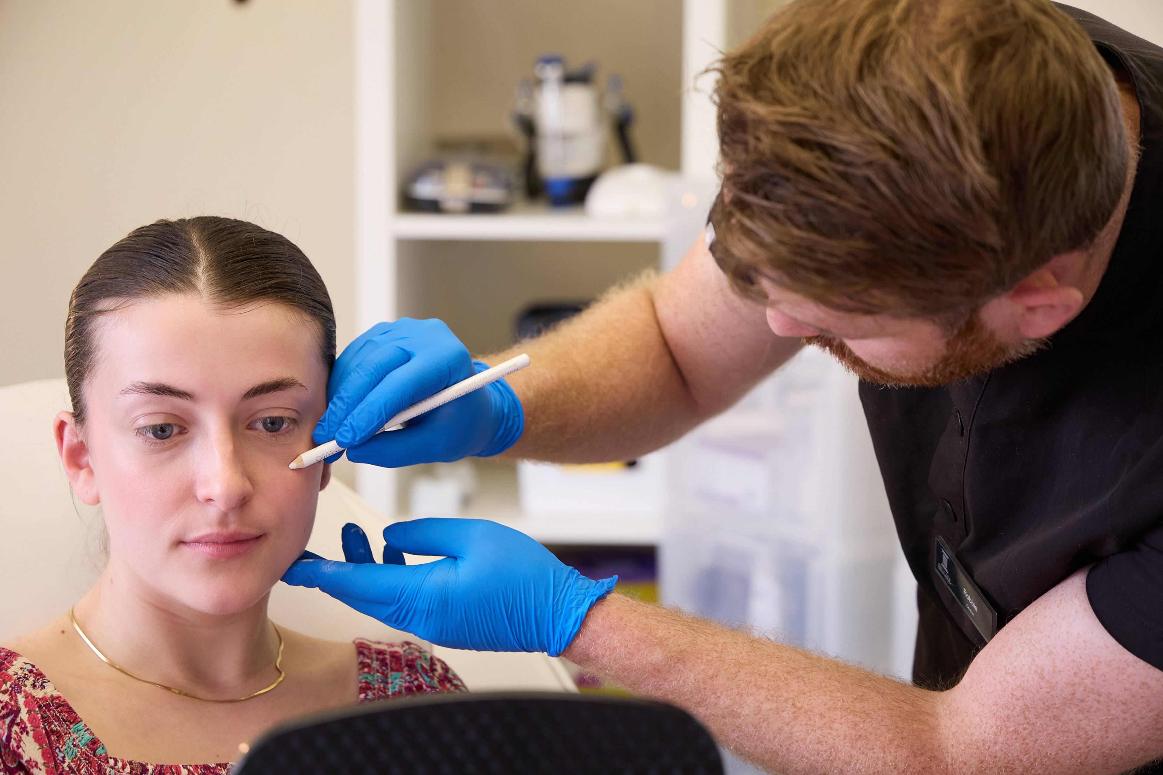 Clinician assessing facial features and marking treatment areas during a facial aesthetics consultation at Bath Spa Dentistry.