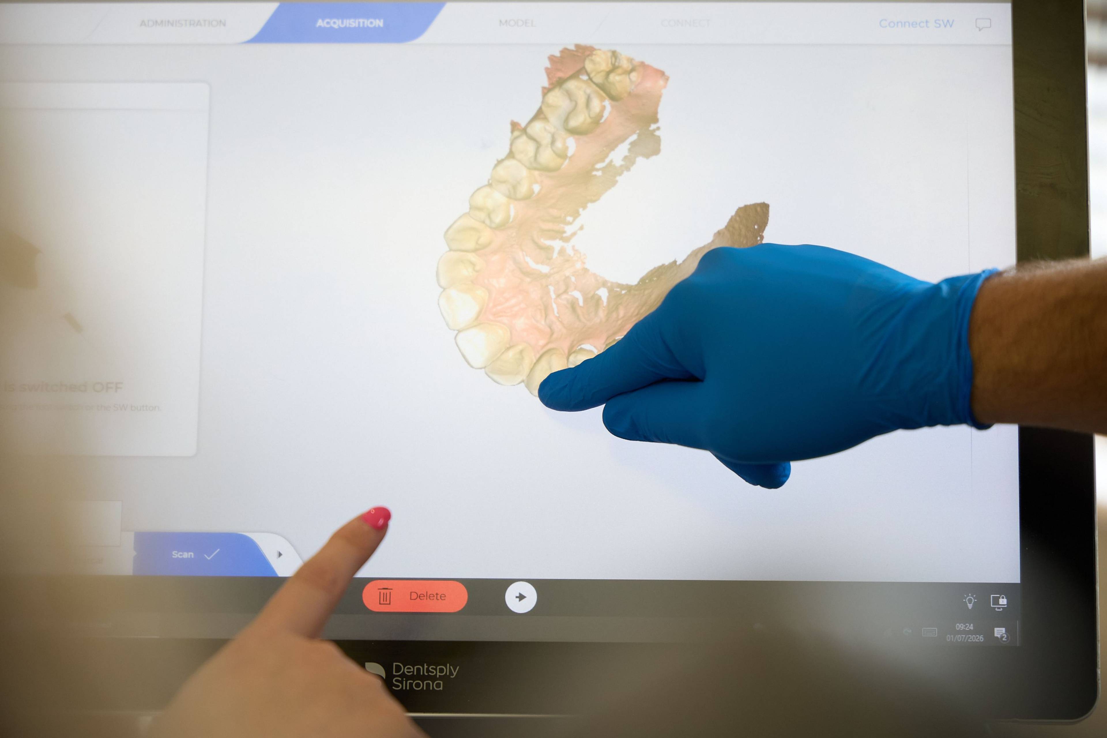 Dentist and patient reviewing a 3D digital scan of teeth on a touchscreen display during a consultation at Bath Spa Dentistry.