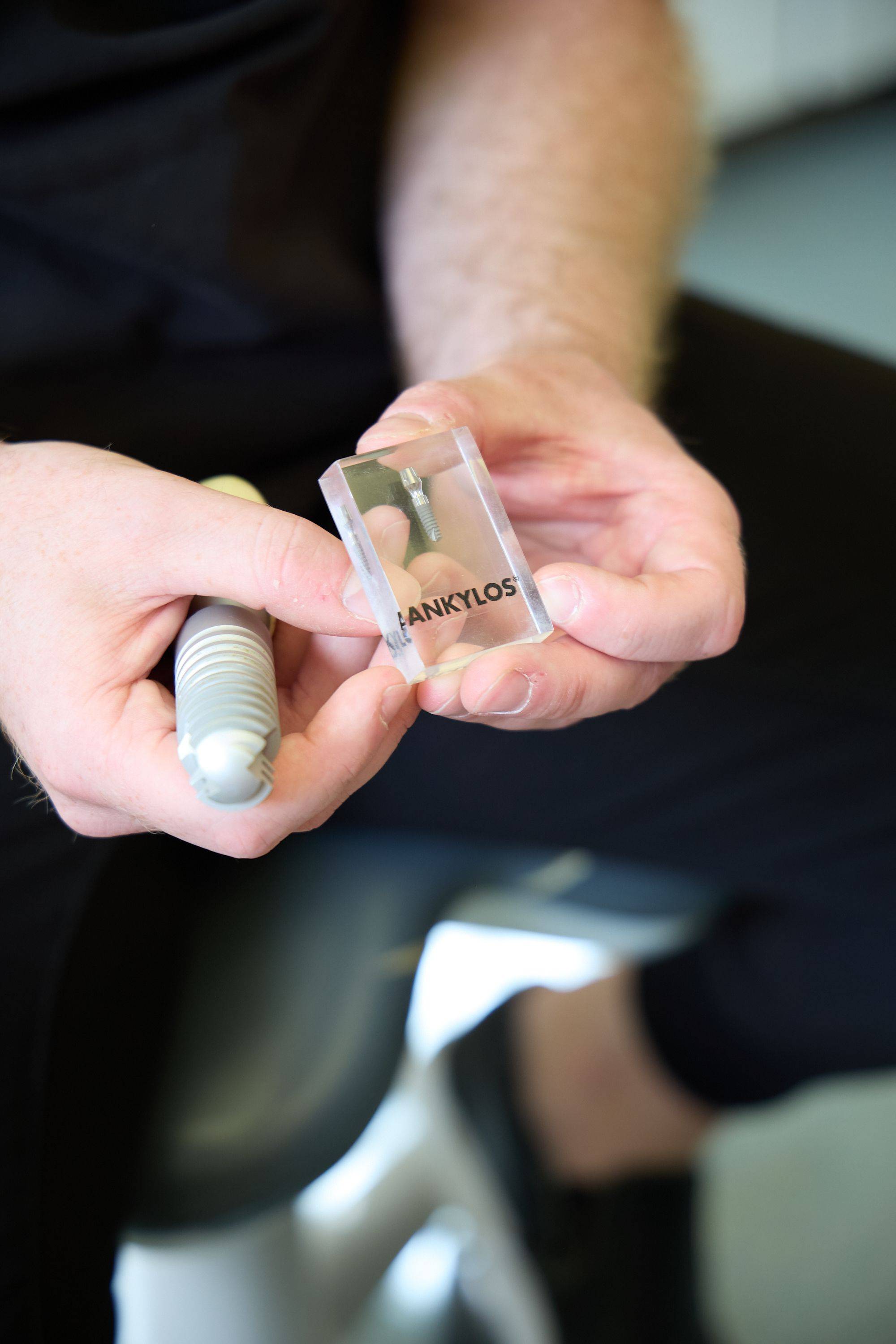 Dental implant model and implant component being demonstrated during a dental implant consultation at Bath Spa Dentistry.