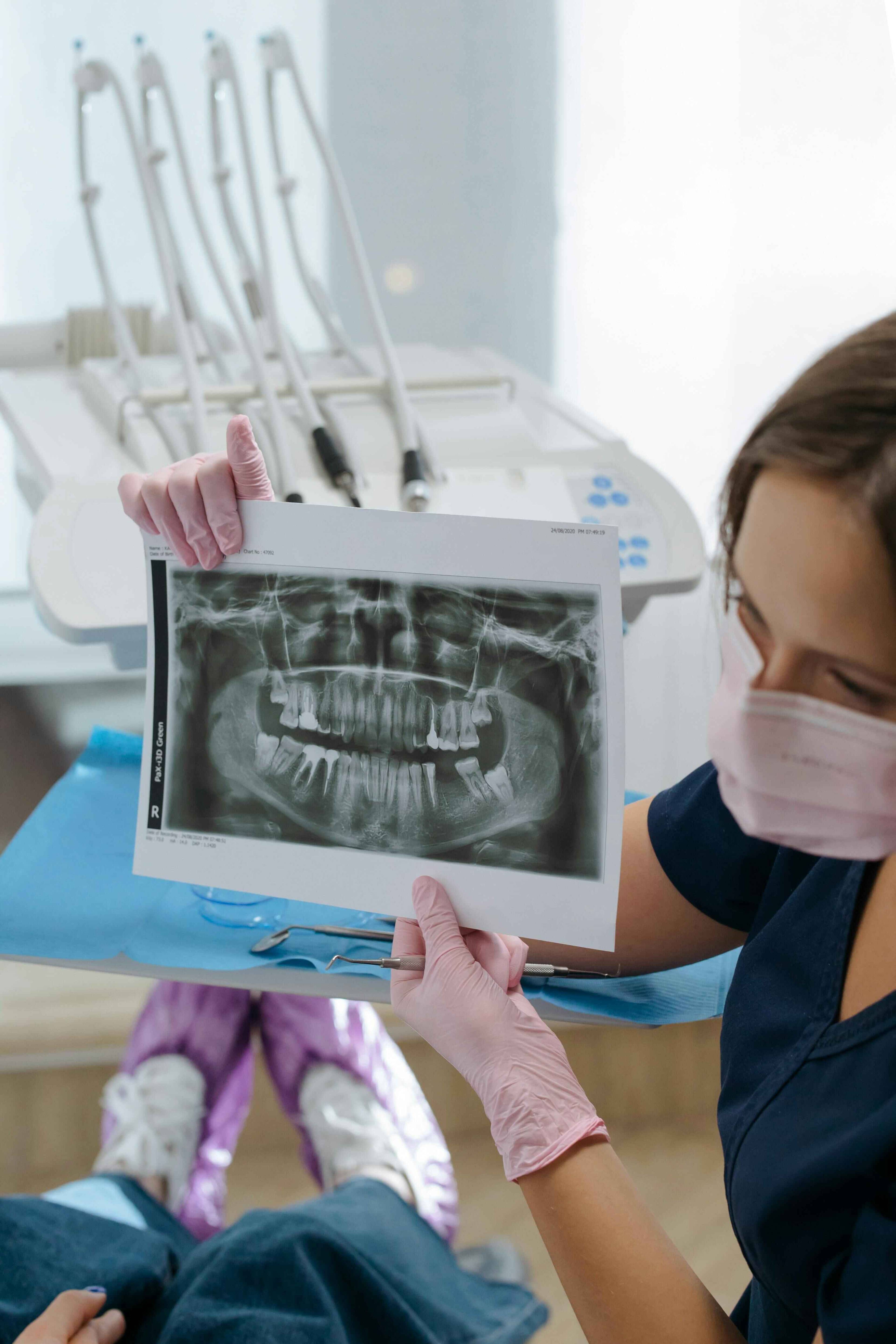 Patient receiving an advanced dental hygiene treatment using Airflow technology and professional cleaning instruments at Bath Spa Dentistry.
