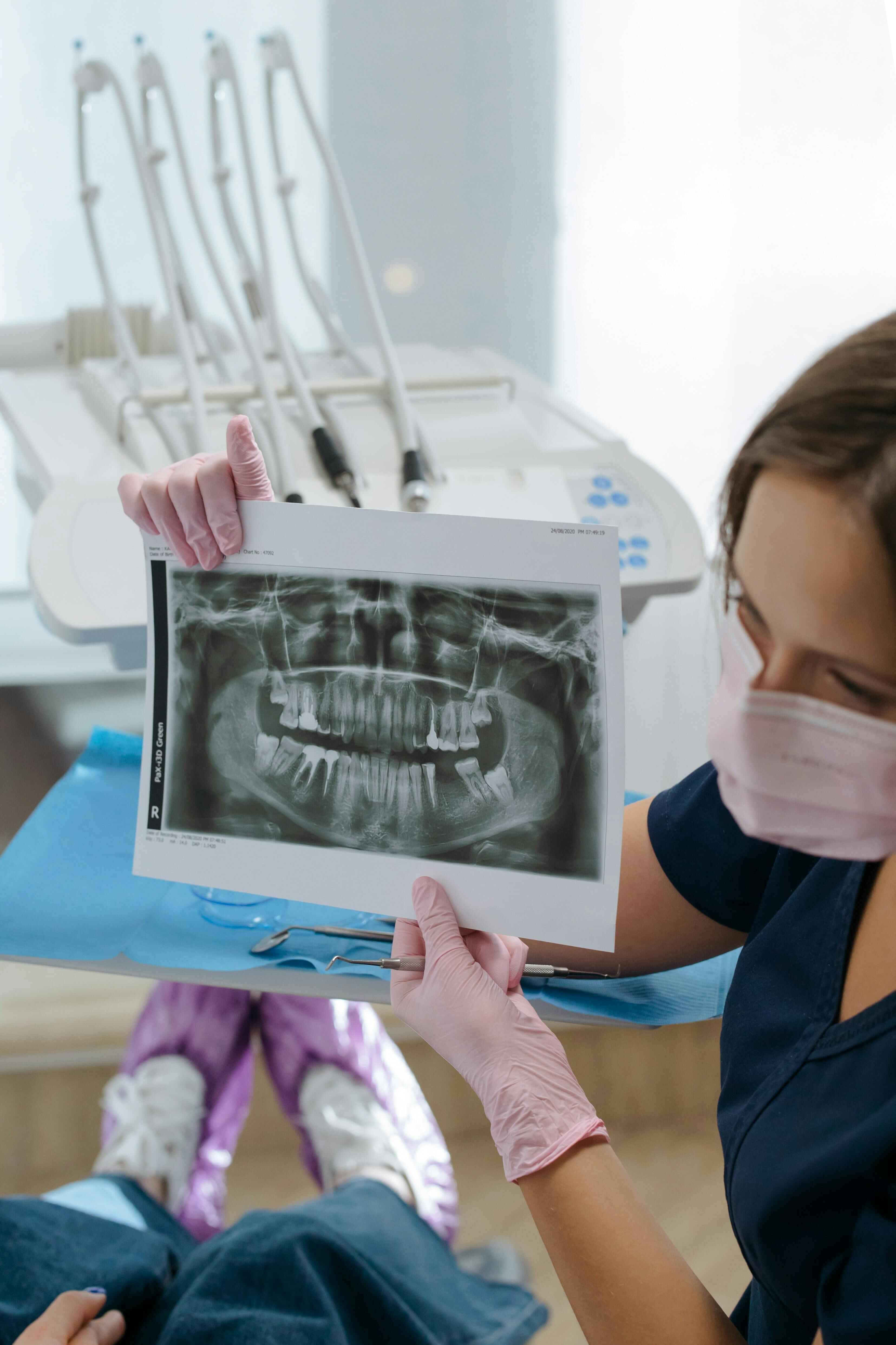 Patient receiving an advanced dental hygiene treatment using Airflow technology and professional cleaning instruments at Bath Spa Dentistry.