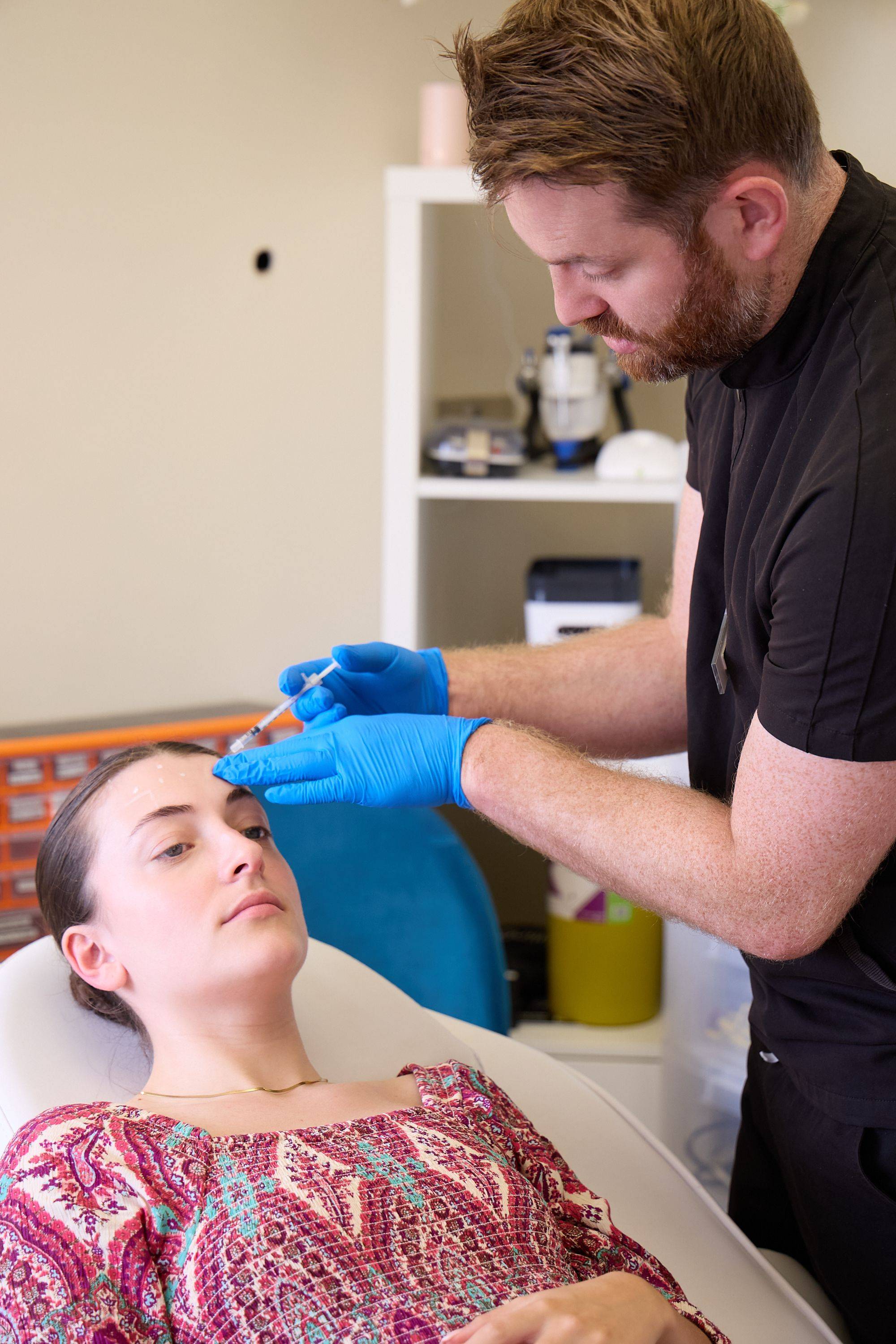 Clinician administering a non-surgical facial aesthetics treatment to a patient during a consultation at Bath Spa Dentistry.