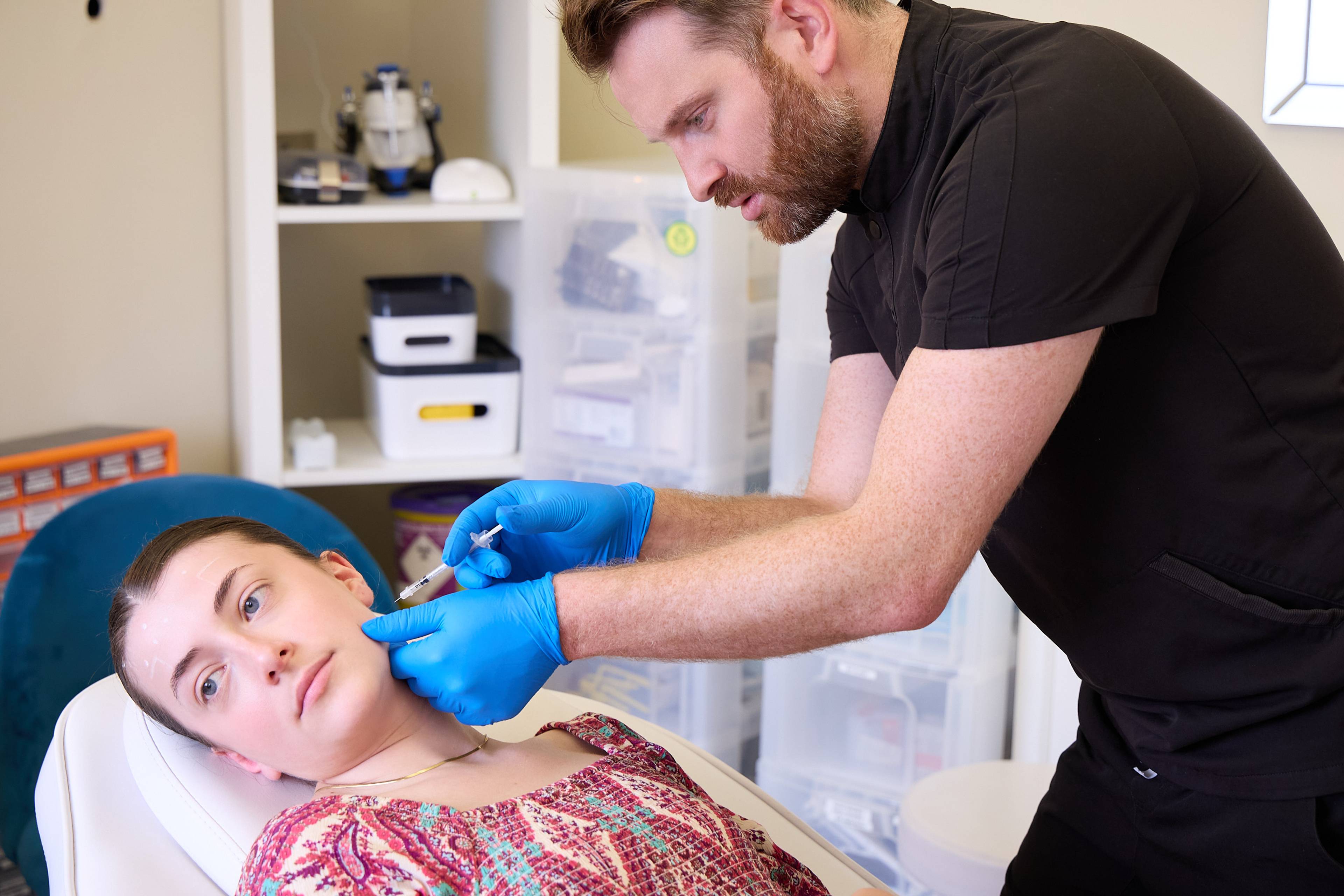 Clinician administering a facial aesthetics treatment to a patient during a consultation at Bath Spa Dentistry.