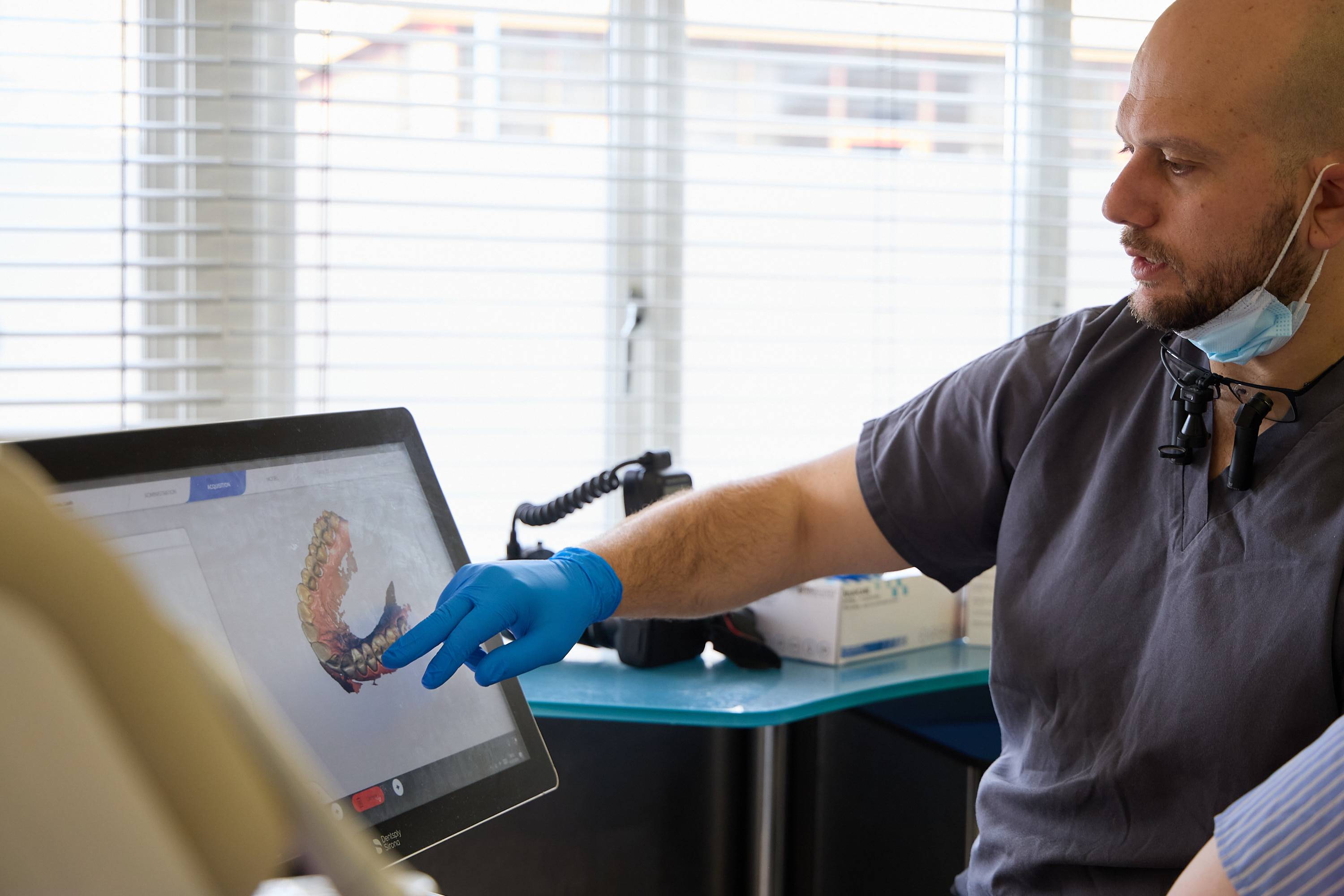 Dentist reviewing a 3D digital scan of a patient's teeth during a treatment consultation at Bath Spa Dentistry.
