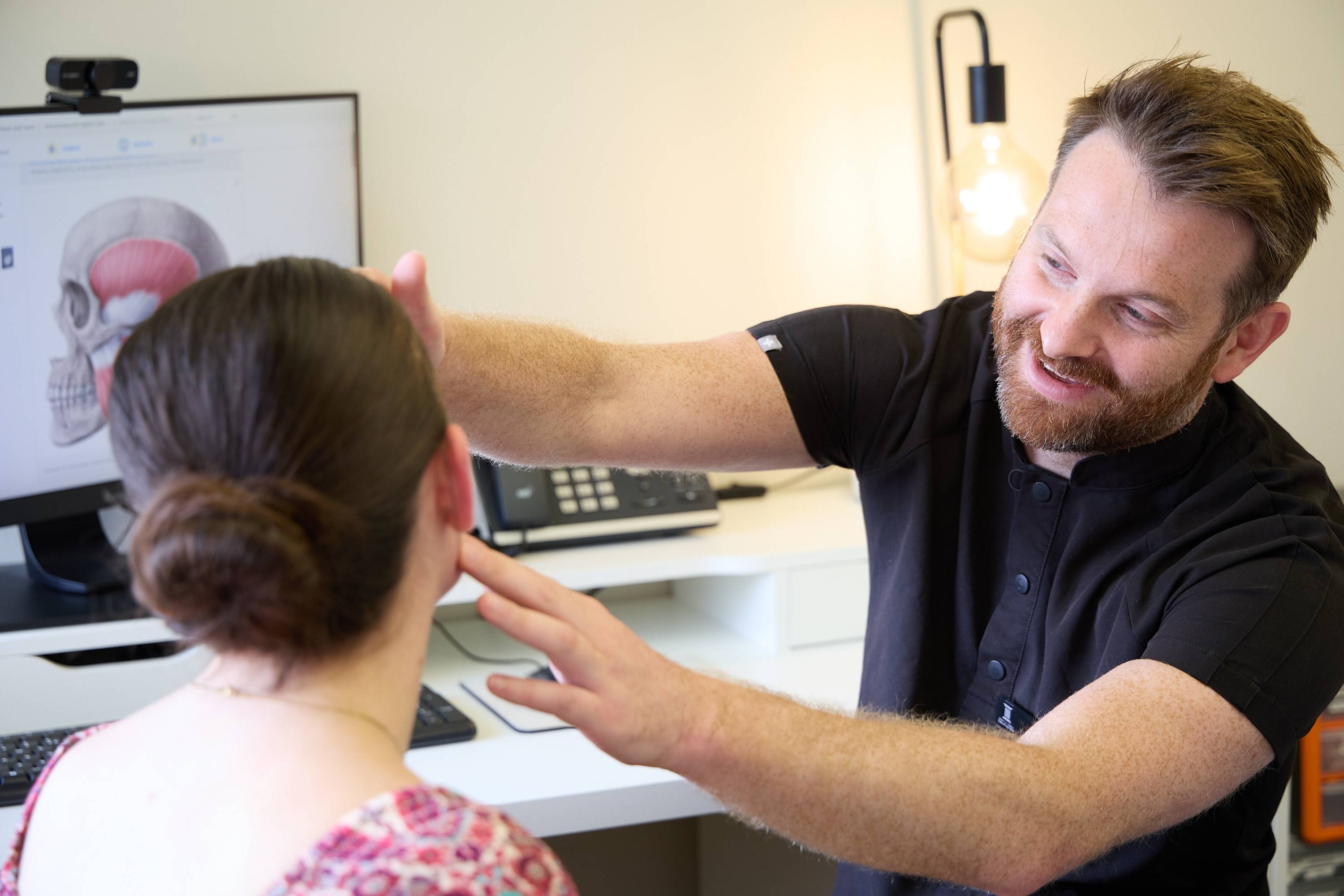 Dental team providing treatment to a patient using modern clinical instruments and suction equipment at Bath Spa Dentistry.