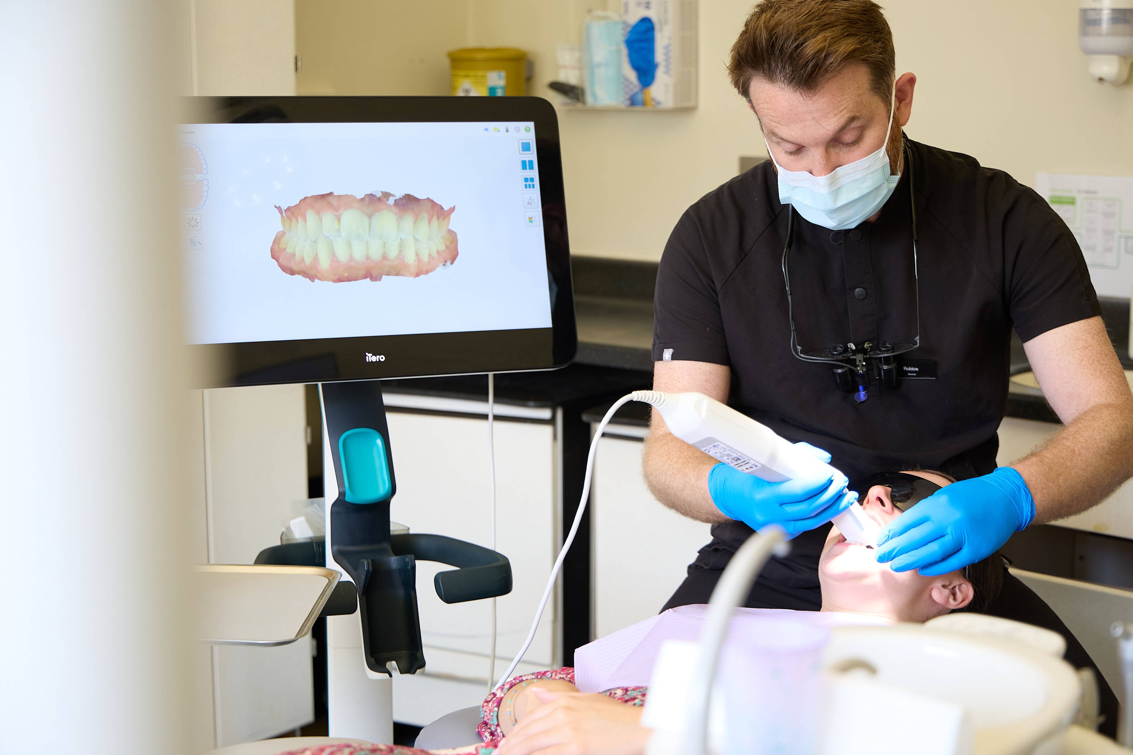 Dentist performing a digital intraoral scan while a 3D model of the patient's teeth is displayed on an iTero scanner at Bath Spa Dentistry.