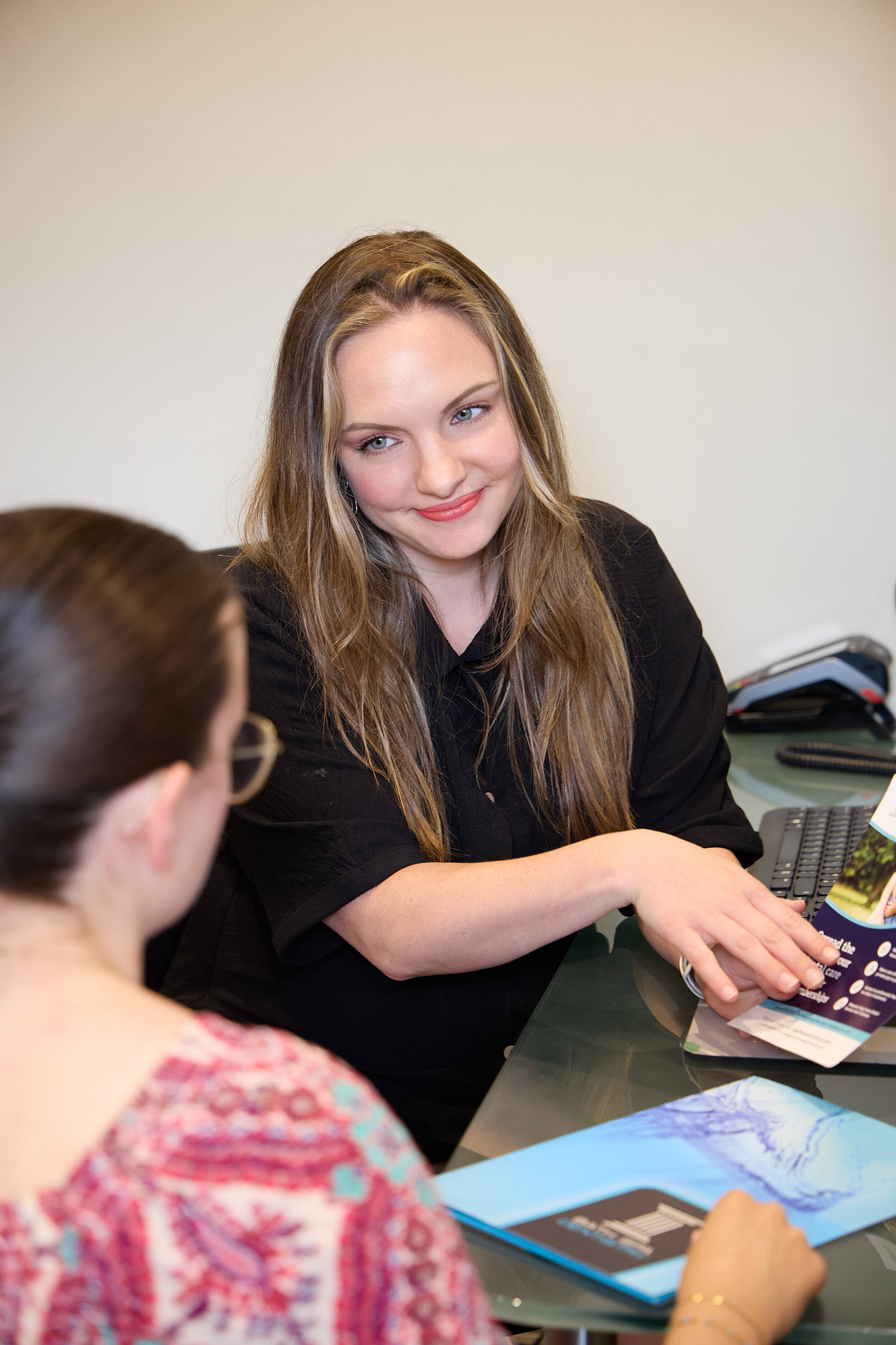 Team member discussing treatment options and patient care information during a consultation at Bath Spa Dentistry.