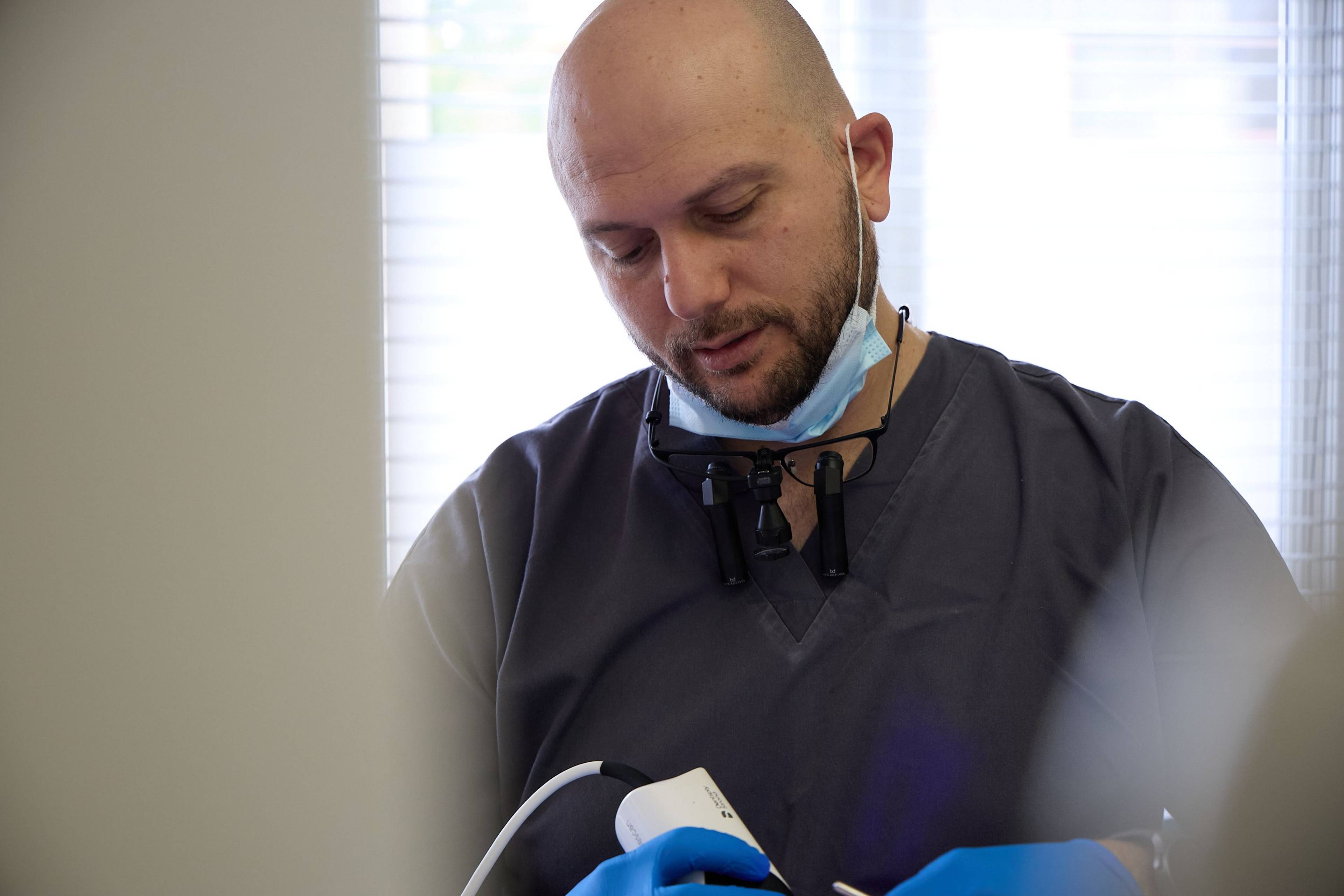 Dental professional using advanced diagnostic equipment during a patient examination at Bath Spa Dentistry.