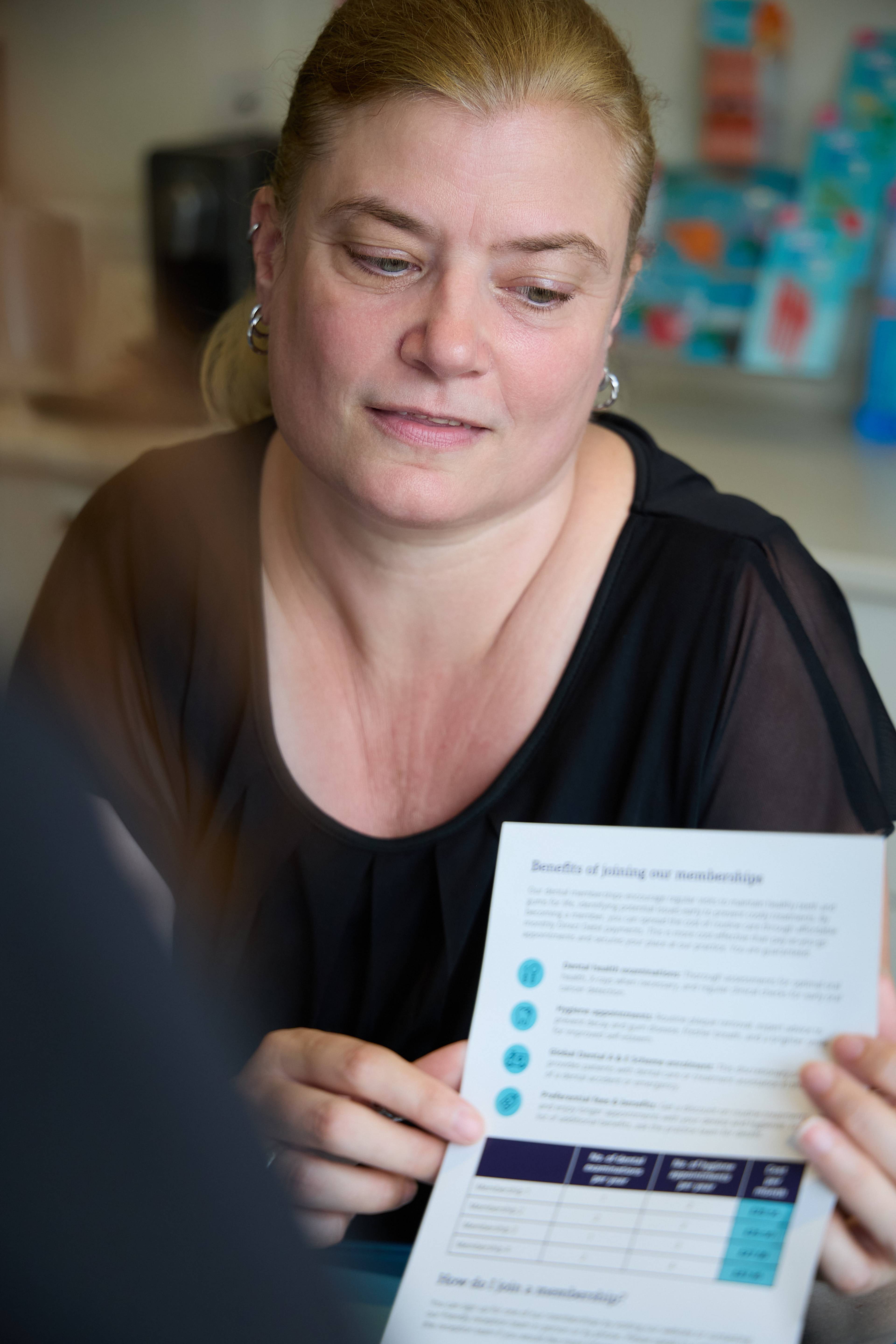Bath Spa Dentistry team member discussing a dental membership plan with a patient during a consultation.