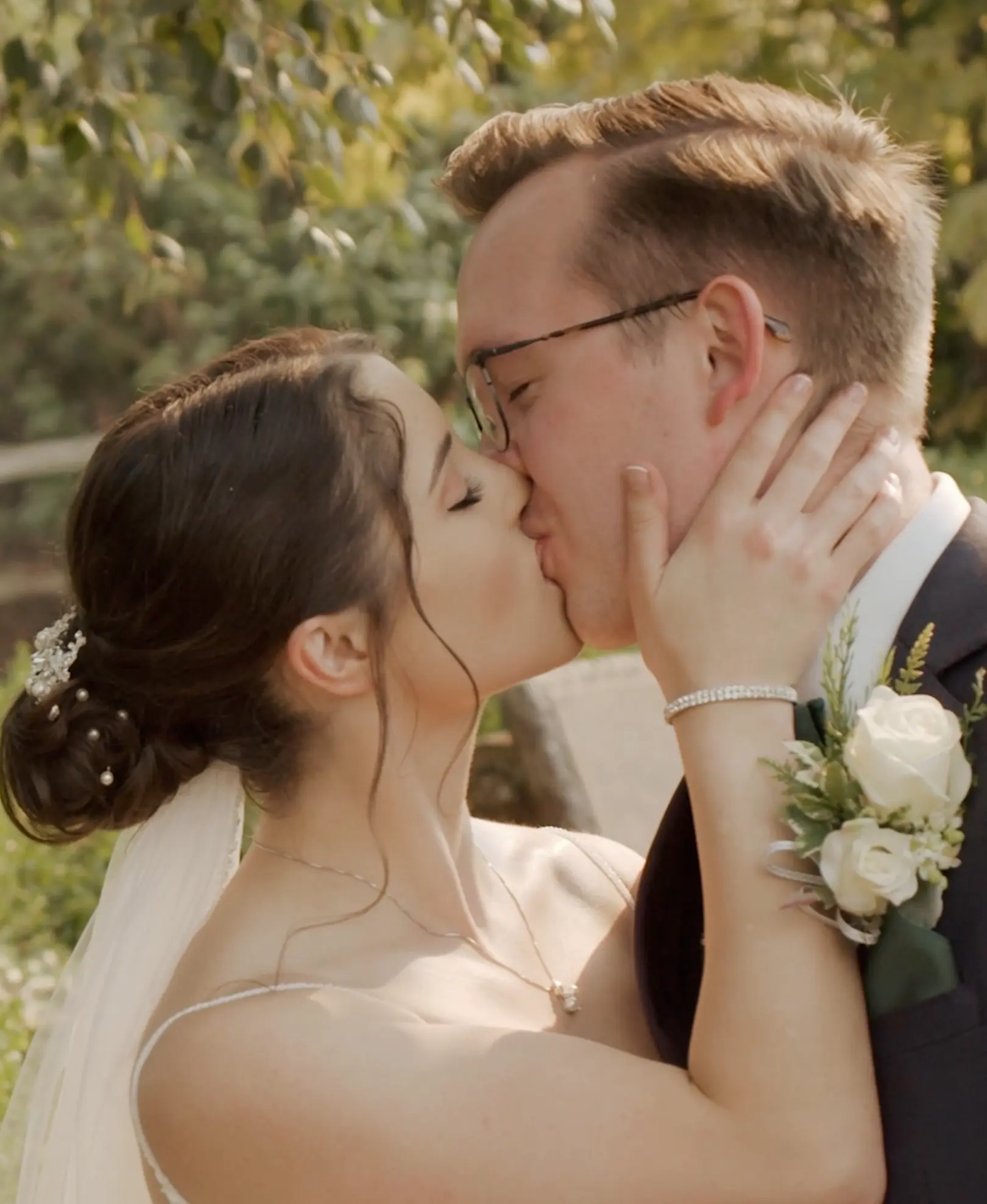 Emily holds Chris' face as they kiss