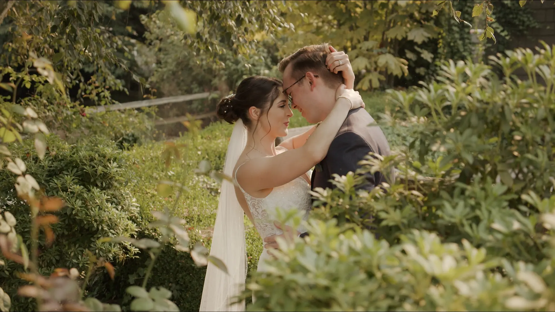 Emily and Chris stare into each other's eyes in a tranquil garden