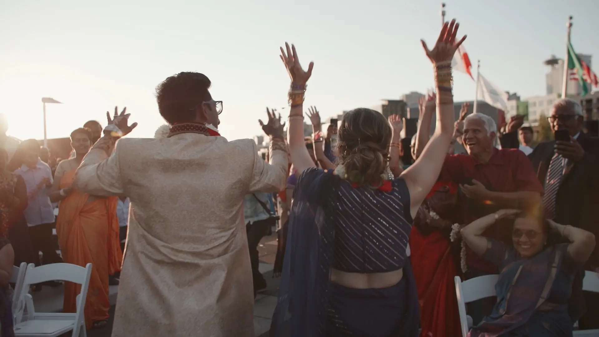 Megan and Anand exit their ceremony to a lively audience at sunset
