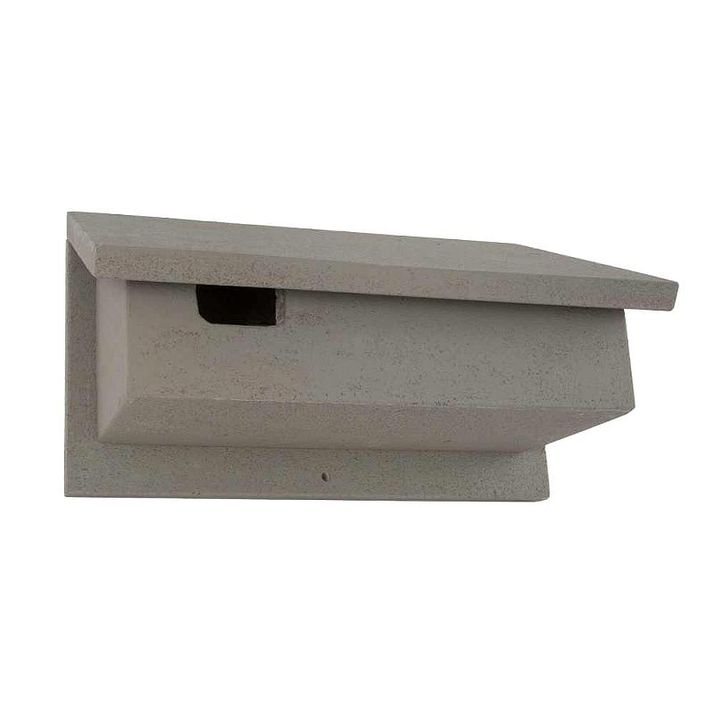 A light gray bat house with a sloped roof and a horizontal entry slot.