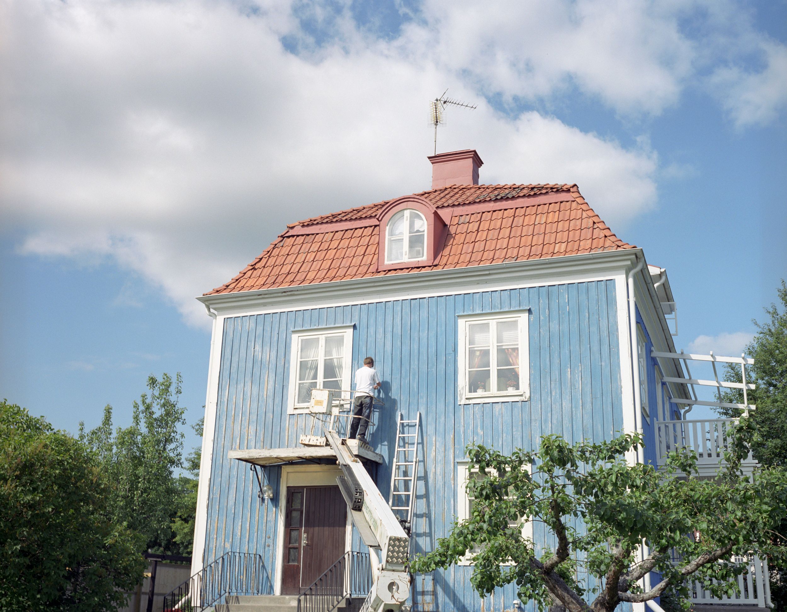 Anticimextekniker inspekterar fönster och fasad på villa