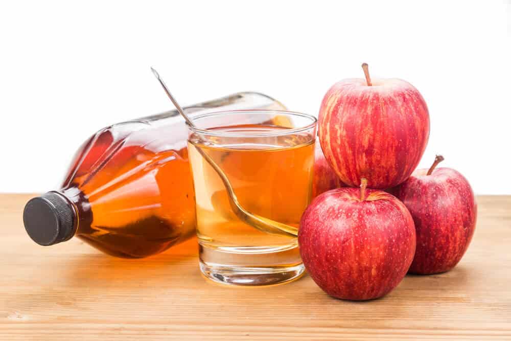 Apple cider vinegar in jar, glass and fresh apple, healthy drink