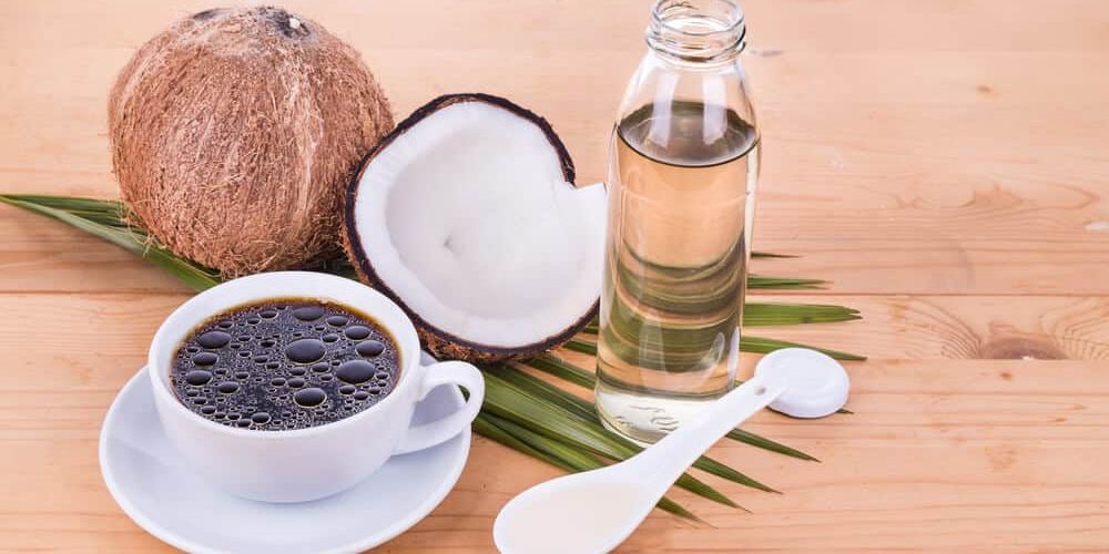 Bulletproof coffee with virgin coconut oil on wooden table