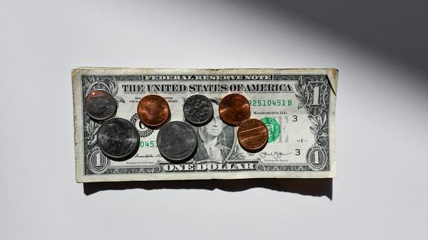 Coins on a dollar bill