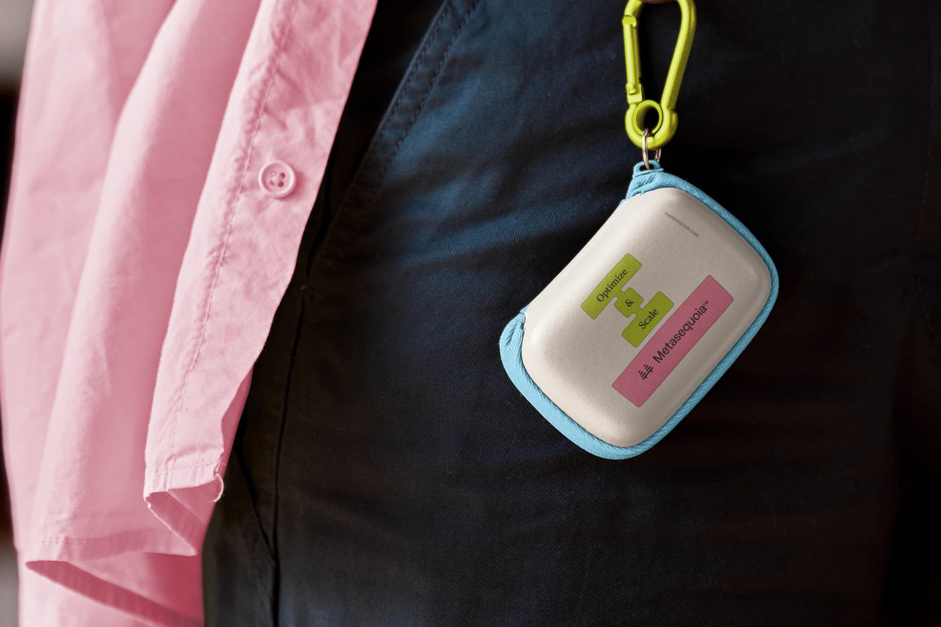 White and blue zip pouch clipped to black clothing beside a pink shirt, printed with “Optimize & Scale Metasequoia” in green and pink.
