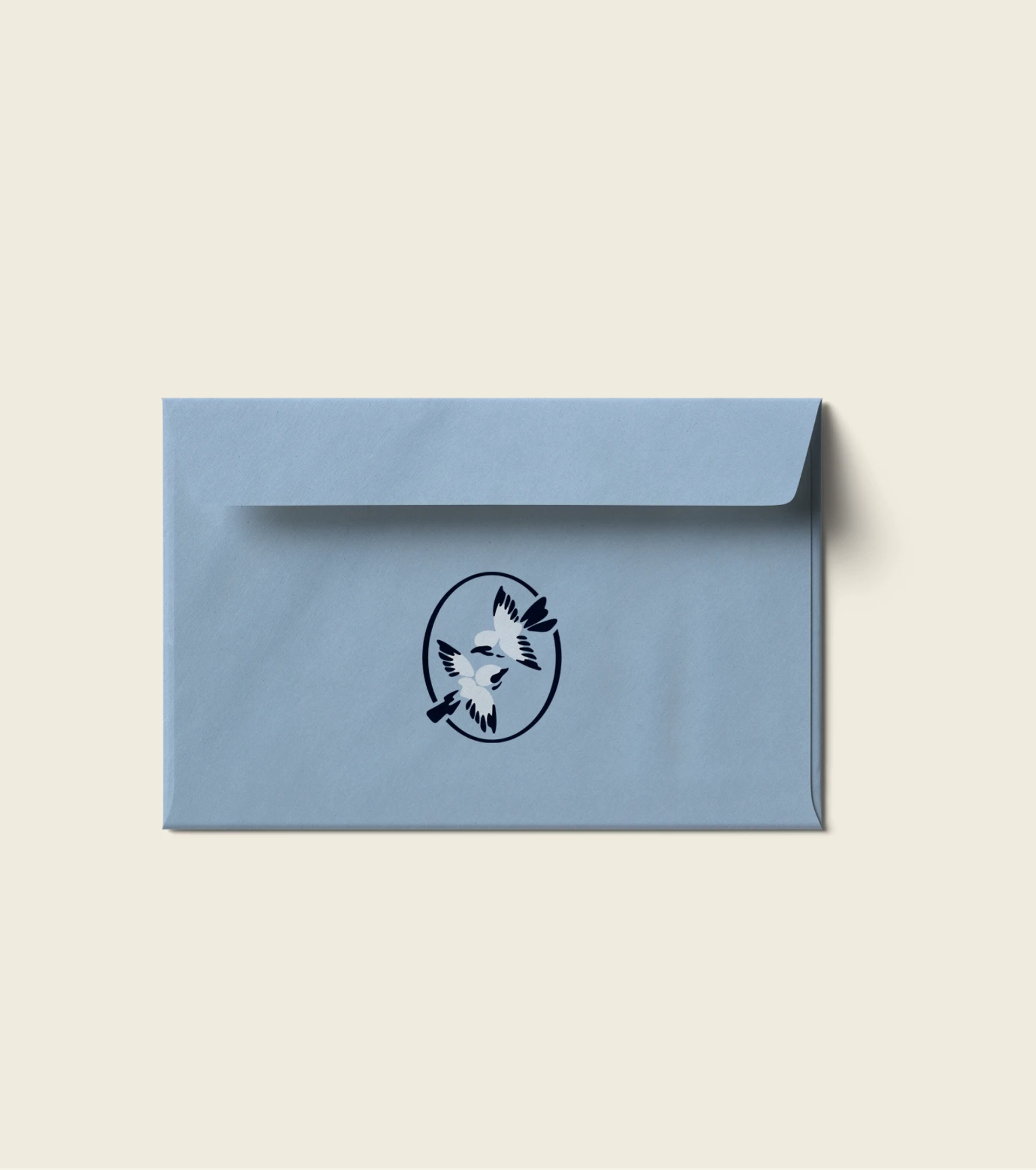 Light blue envelope with a navy and white emblem of two flying birds, centered on a cream background.