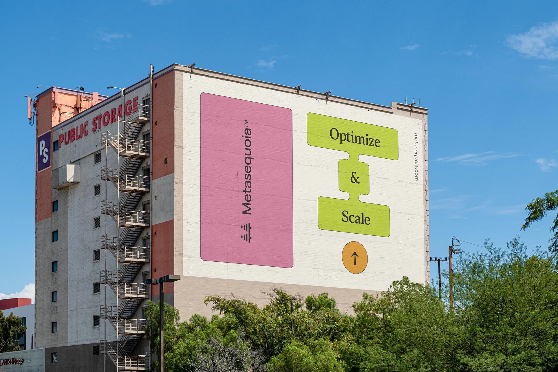 Building mural with pink Metasequoia panel and green “Optimize & Scale” graphics beside red “PUBLIC STORAGE” signage.