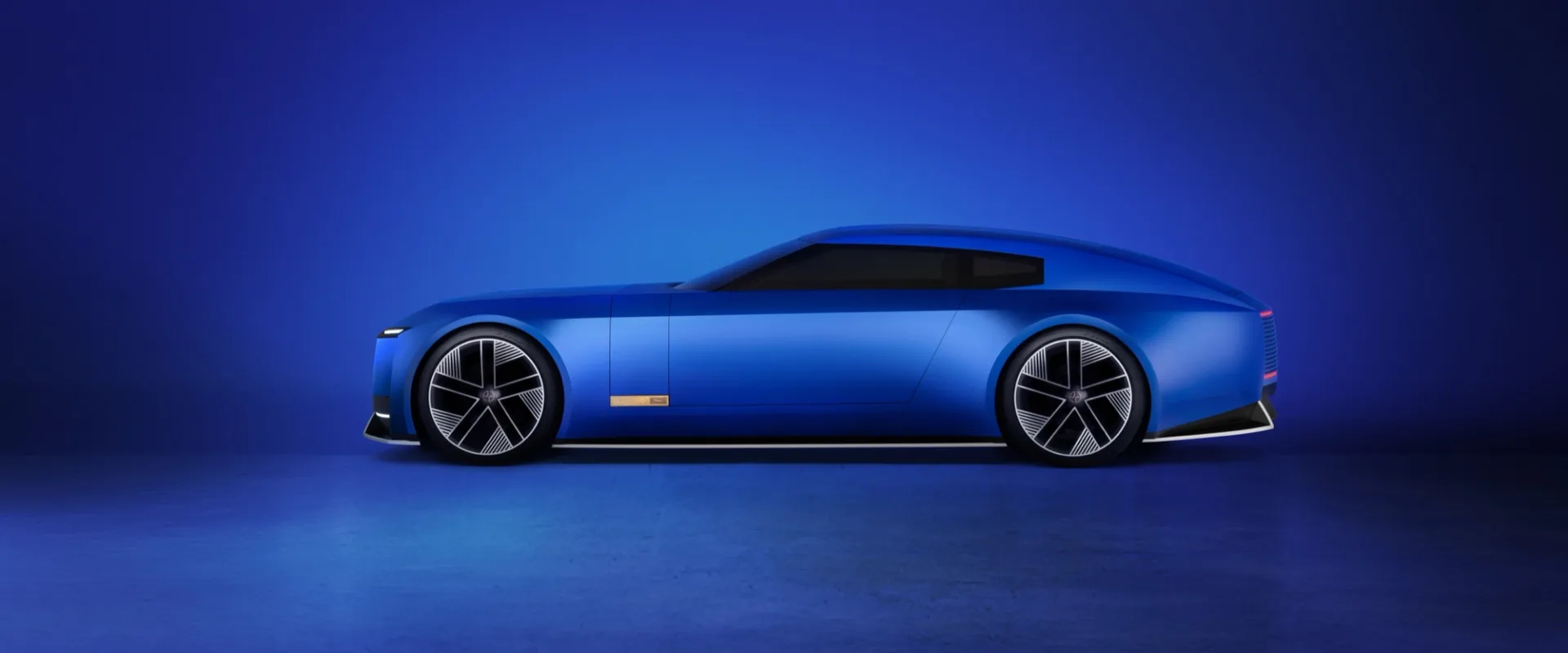 Jaguar Type 00 concept in French Ultramarine, side profile, against a blue field