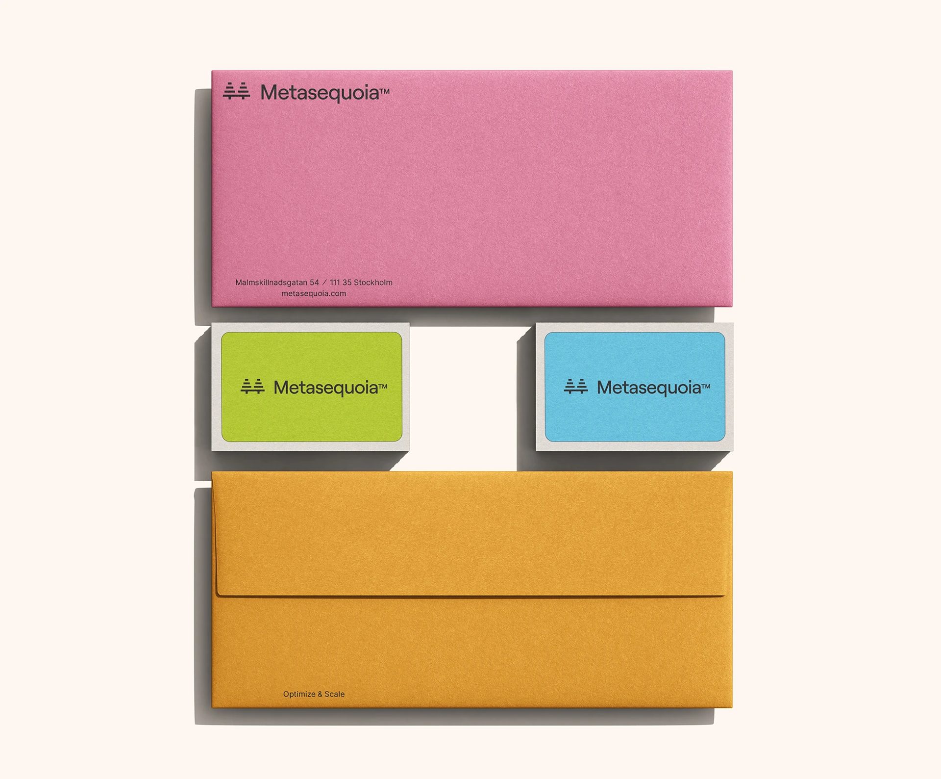 Metasequoia™ stationery with a pink letterhead, green and blue business cards, and a mustard envelope.
