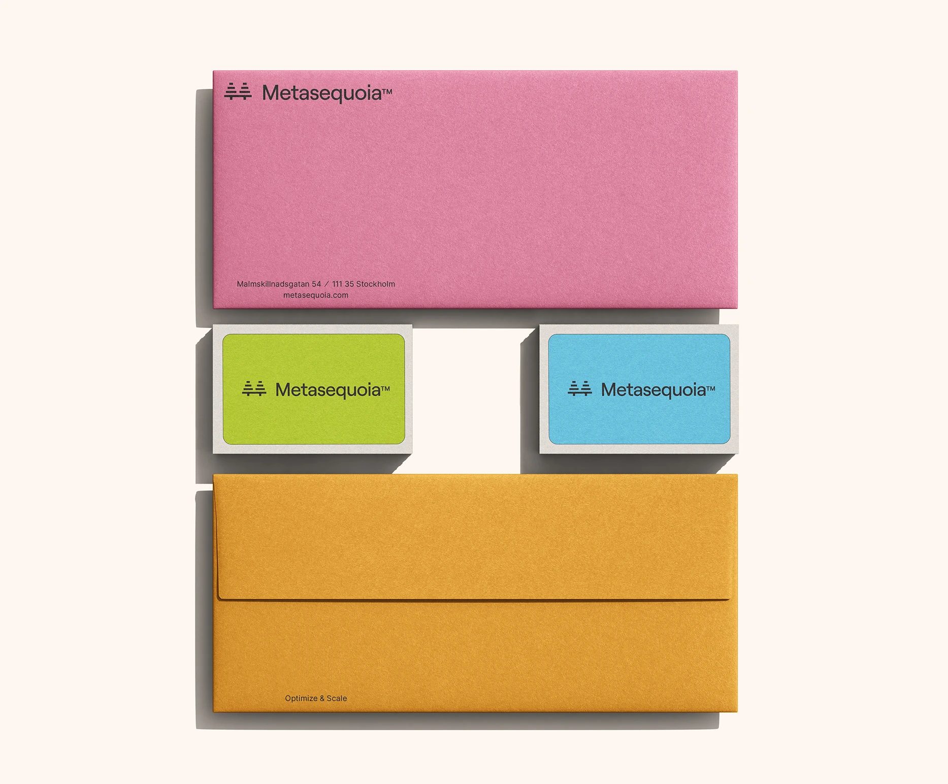 Metasequoia™ stationery with a pink letterhead, green and blue business cards, and a mustard envelope.