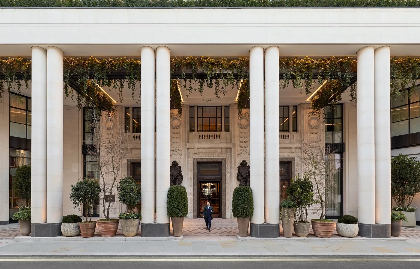 The colonnaded facade of Six Senses London at The Whiteley, planted and open to the street