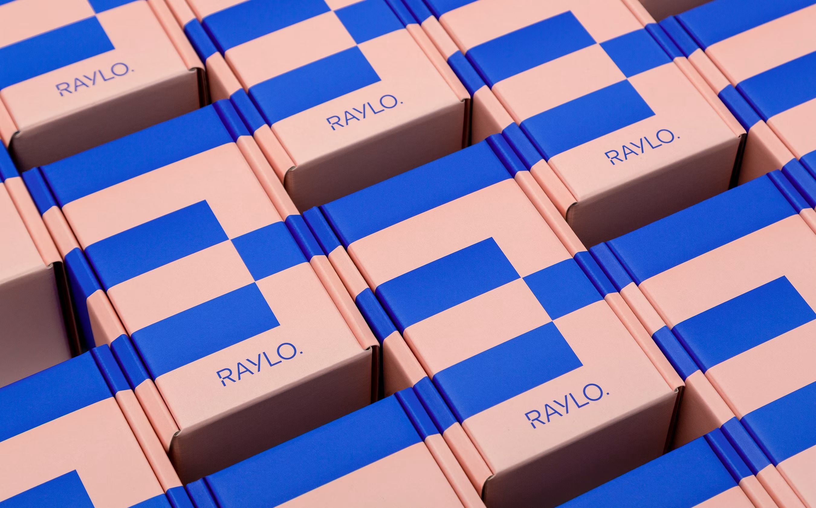 Raylo packaging boxes in soft pink carrying the two-colour switch pattern in pop blue